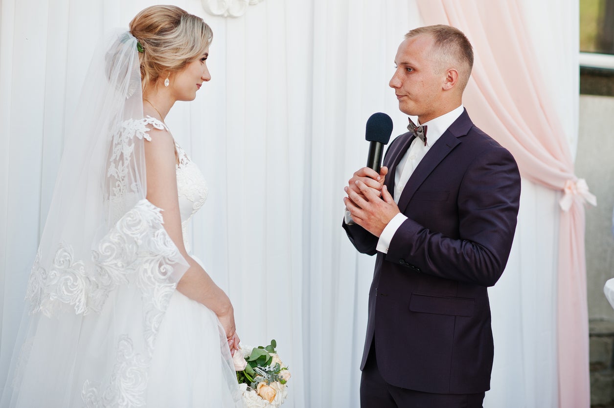 Groom giving a speech to his bride at wedding