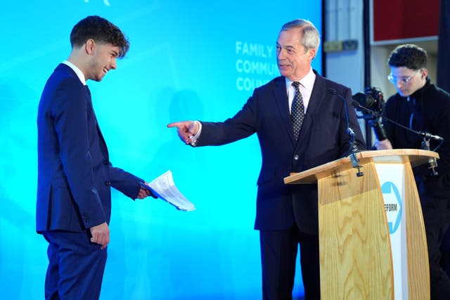 Former councillor Harrison Allman-Varty joins Reform UK leader Nigel Farage onstage as he announces he is defecting from the Conservative party to join Reform UK (Jonathan Brady/PA)