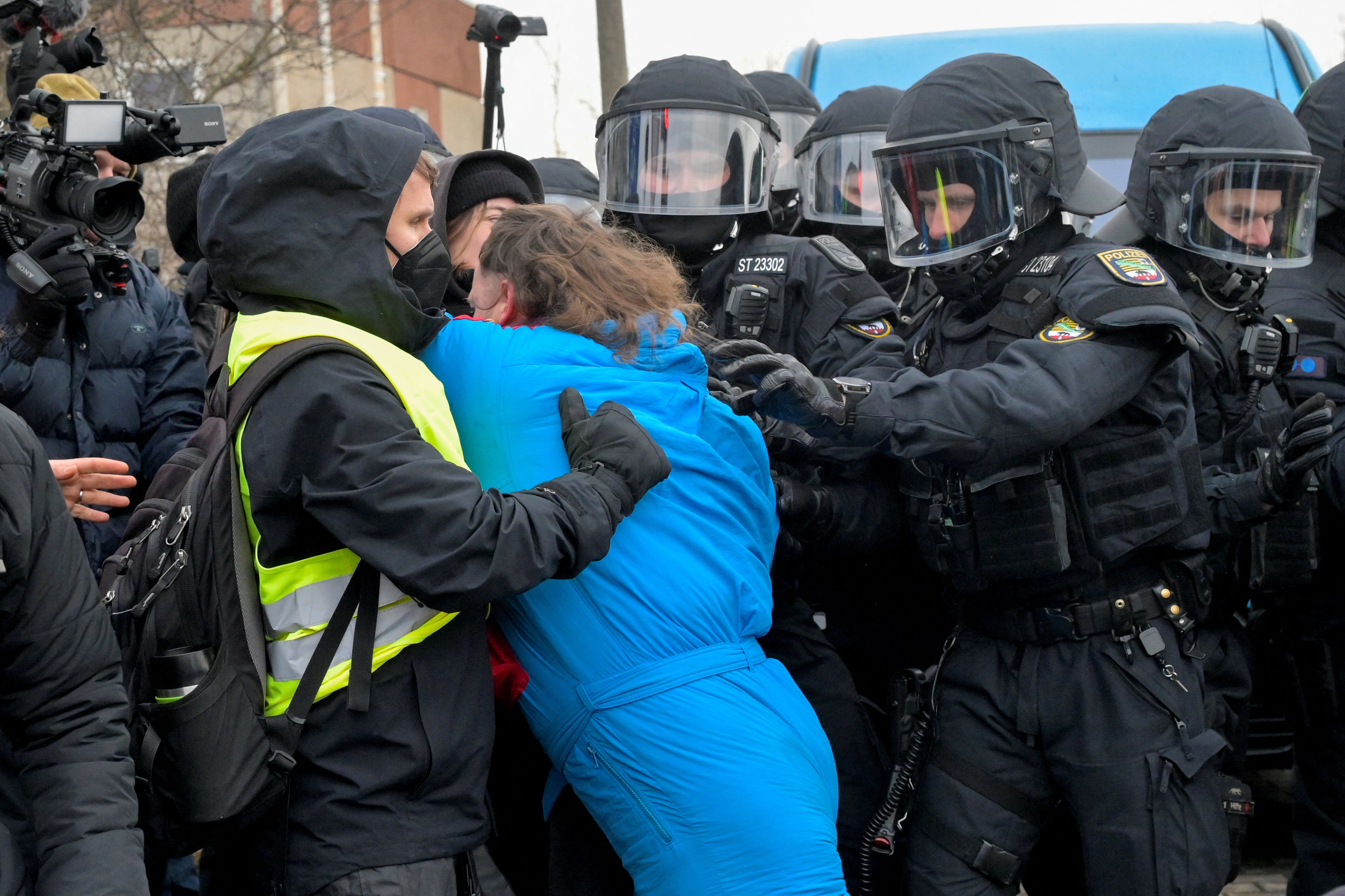 Police officers deal with protesters outside the AfD rally in Riesa, Germany