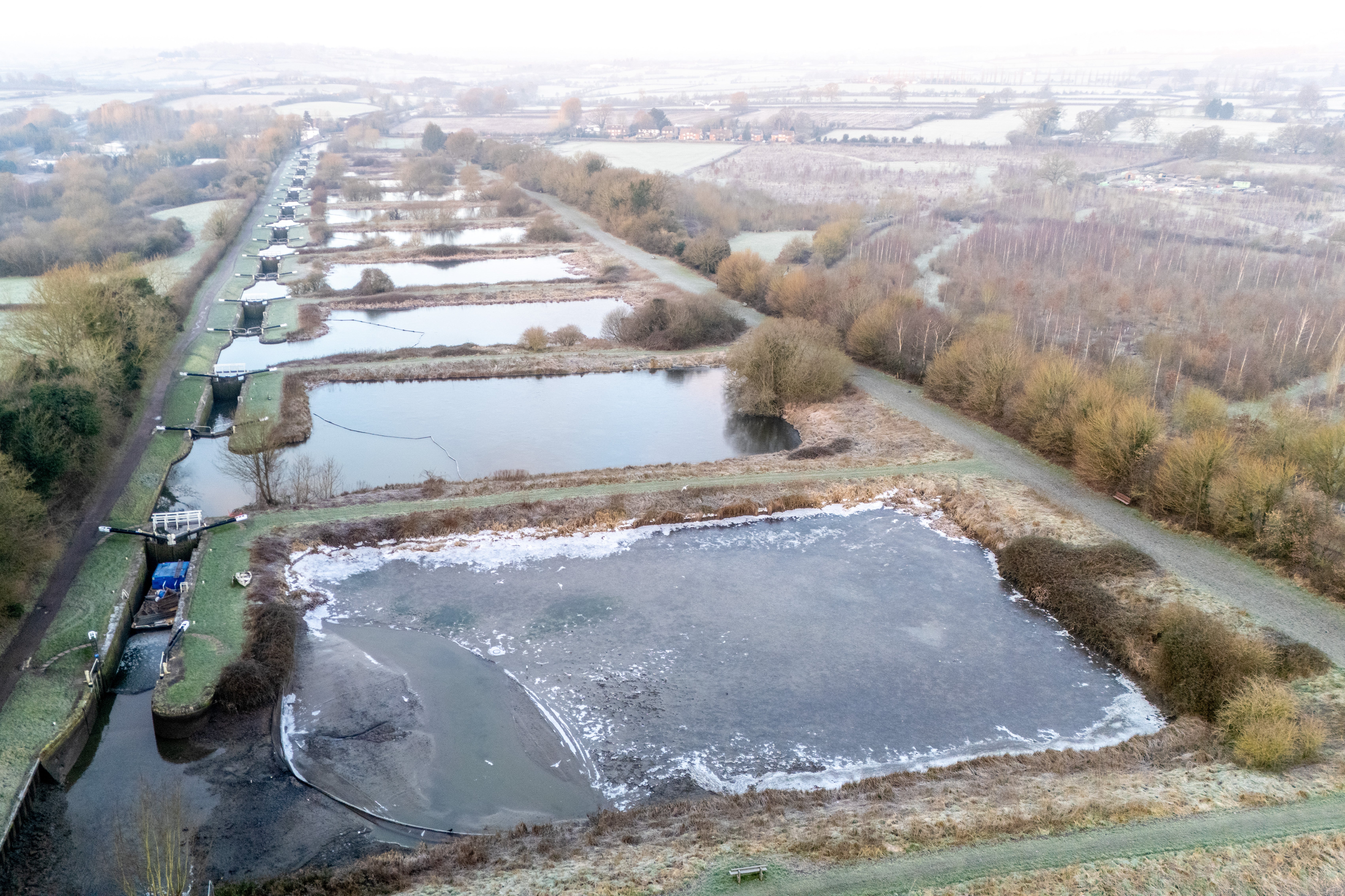 Ice forms on the water as the temperature hits -4C (minus four) during sunrise over the 16 locks that form the steepest part of the flight at Caen Hill Locks in Devizes, Wilsthire