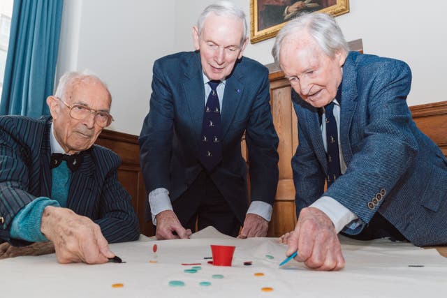 Bill Steen, Peter Downes and Lawford Howells celebrate the 70th anniversary of competitive tiddlywinks. (Cambridge University/PA)