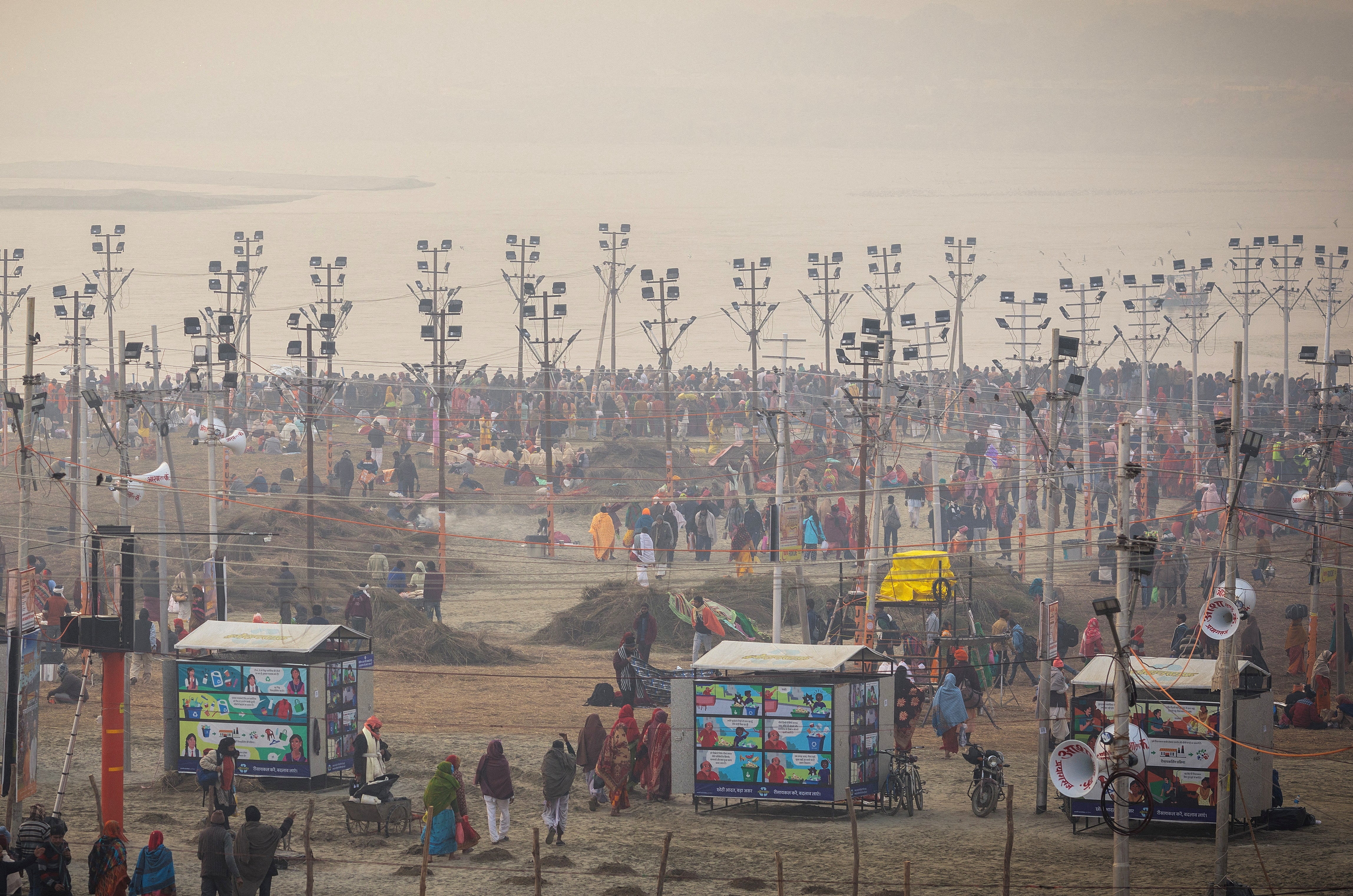 Devotees gather to take a holy dip at Sangam, the confluence of the Ganges, Yamuna and Saraswati rivers ahead of the “Maha Kumbh Mela”