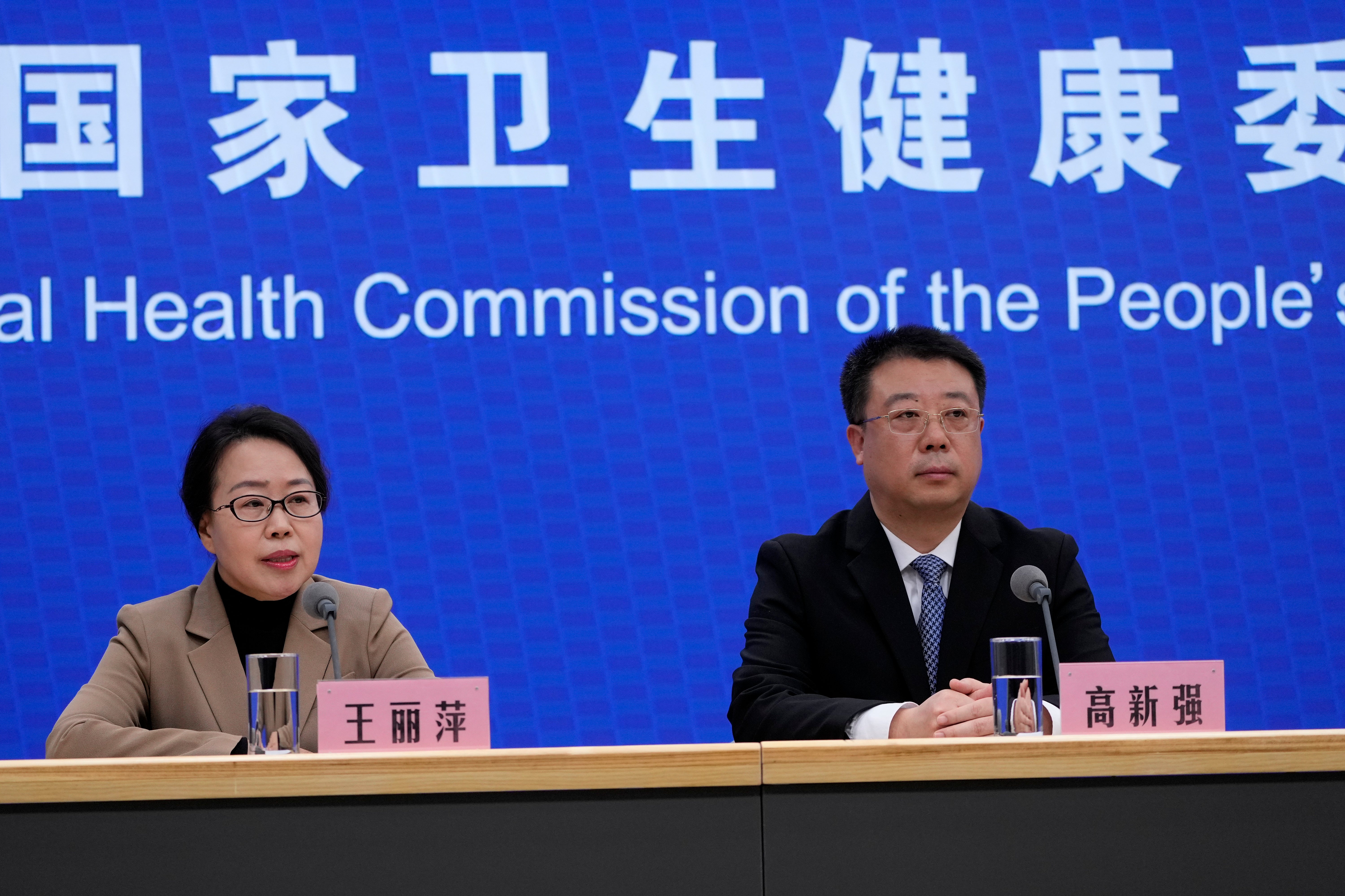 Wang Liping, left, researcher for the Chinese Center for Disease Control and Prevention speaks during a press briefing by the National Health Commission as concerns surfaced in recent days over a surge in human metapneumovirus (HMPV) infections in northern China after images circulated online of hospitals overrun with masked patients, in Beijing, Sunday, Jan. 12, 2025. (AP Photo/Andy Wong)