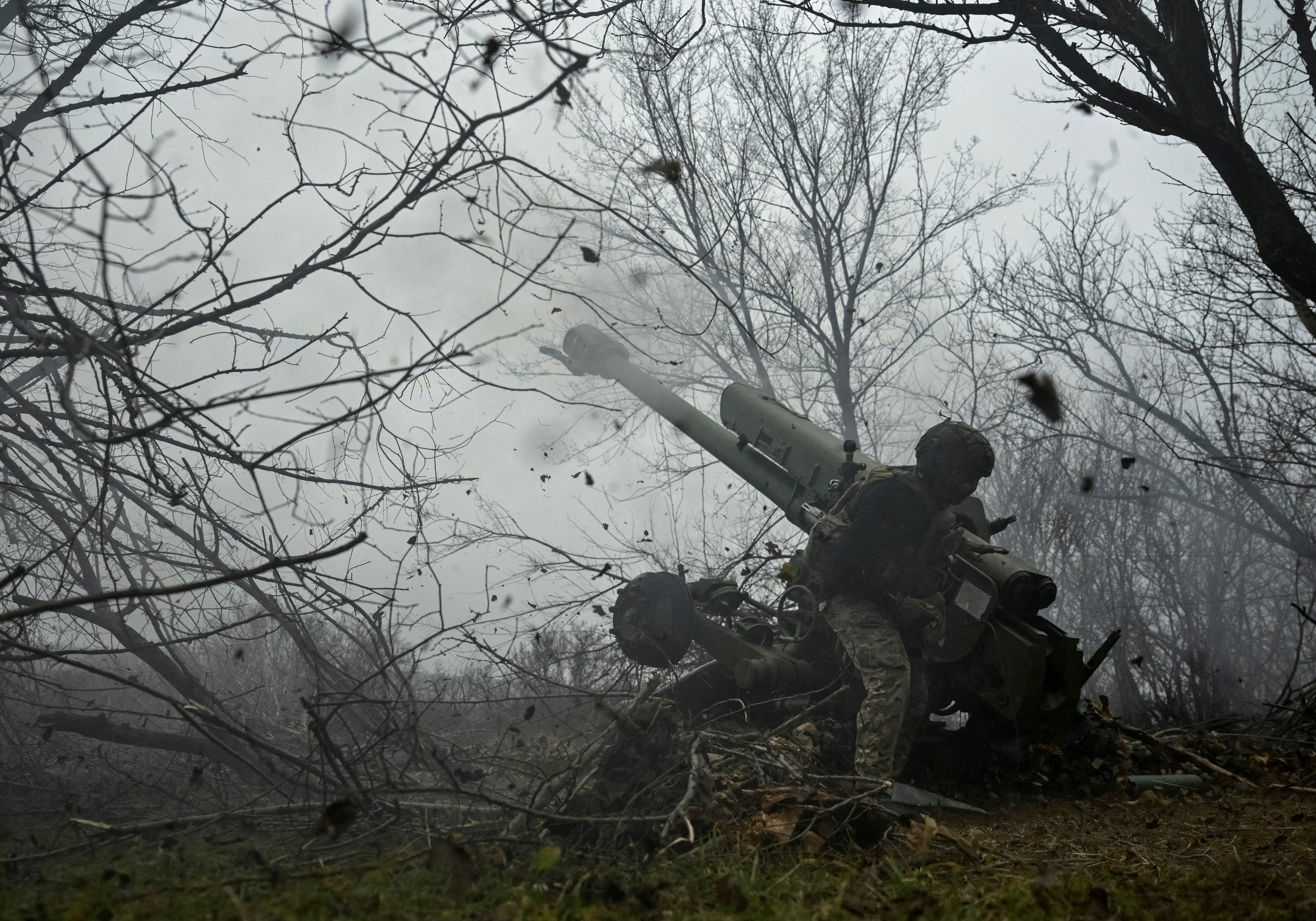 A serviceman of the artillery crew of the special unit National Police fires a D-30 howitzer towards Russian troops at a position in a front line