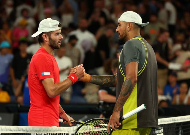 <p>Fearnley, left, shakes hands with Kyrgios after the 7-6 6-3 7-6 win </p>