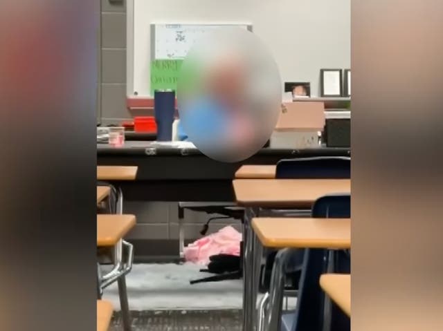 <p>Video footage from inside the classroom where Kenneth Hartley was teaching on Friday, shows the teacher sitting behind a desk where his students say he was watching porn</p>