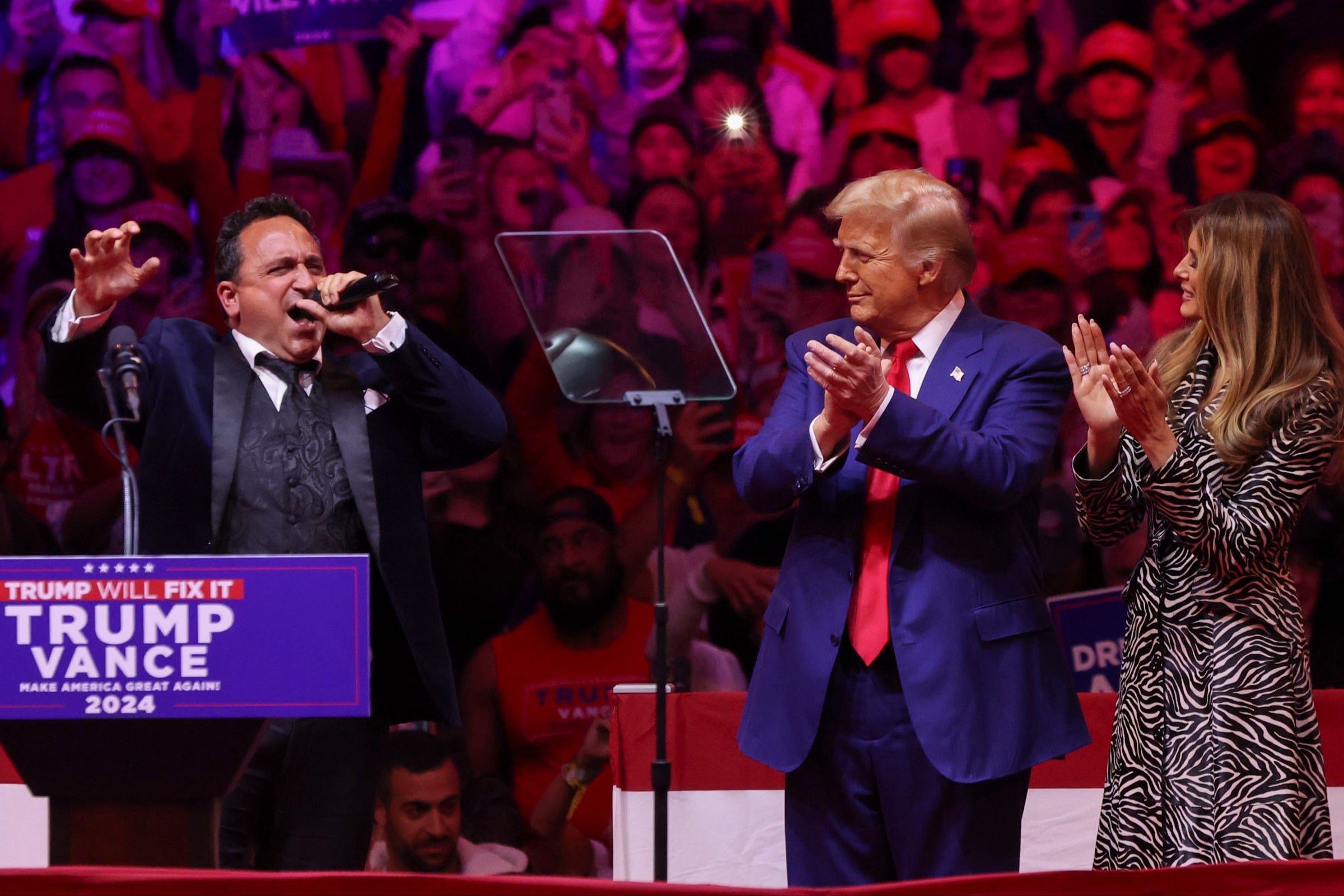 Trump claps as Christopher Macchio performs at his Madison Square Garden rally