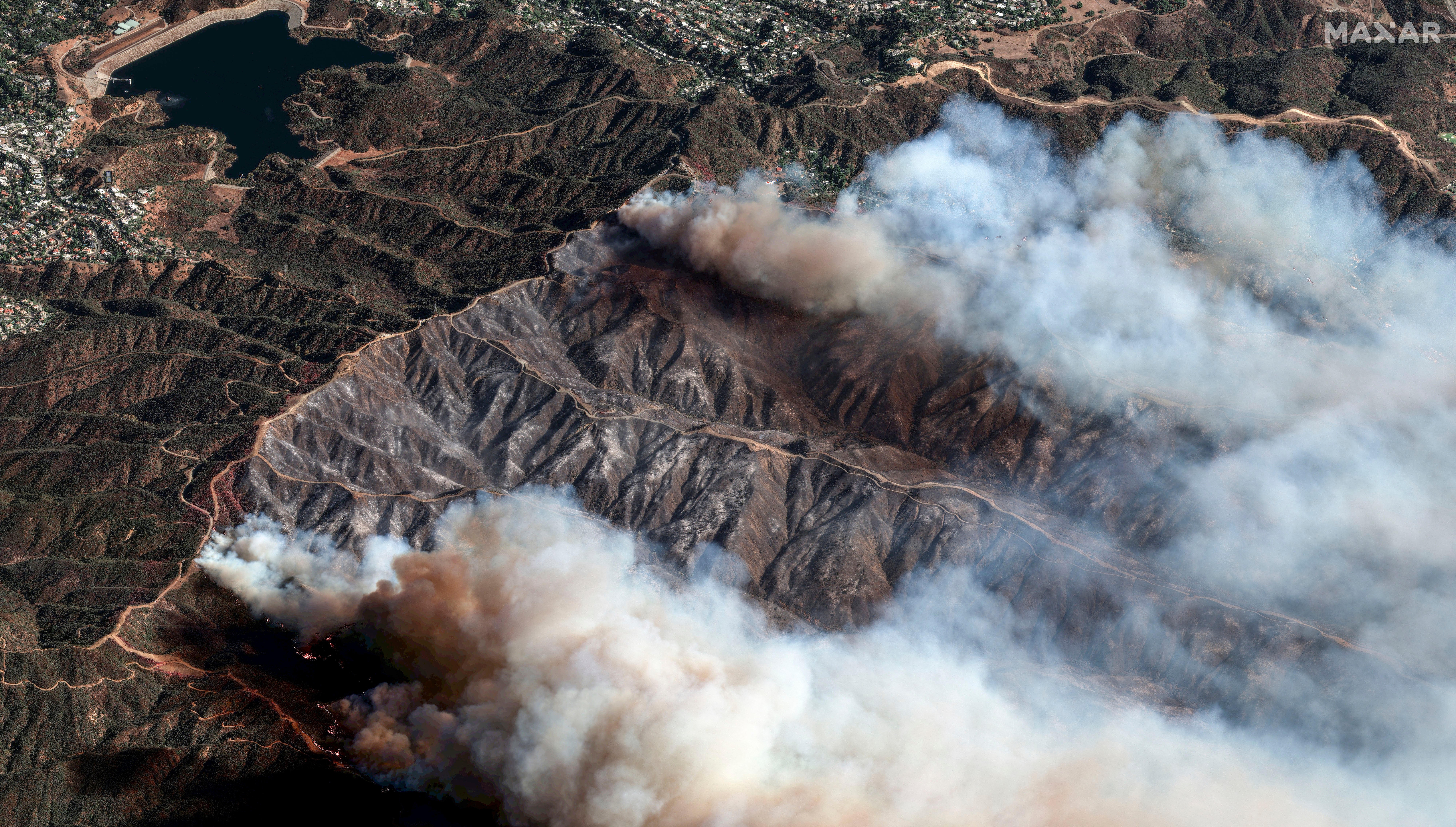 In this photo provide by Maxar Technologies, the Palisades Fire burns i California on Saturday. The fire has spread over more than 23,000 acres