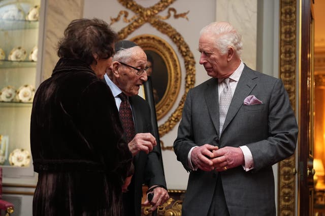 King Charles III speaks to Holocaust survivor Manfred Goldberg and his wife Shary Goldberg during a reception marking Holocaust Memorial Day (Aaron Chown/PA)