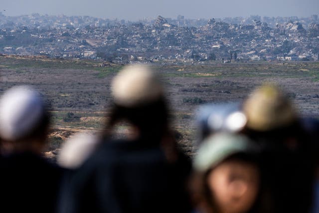 People watch the Gaza Strip from an observation point in Sderot, southern Israel (Ariel Schalit/AP)