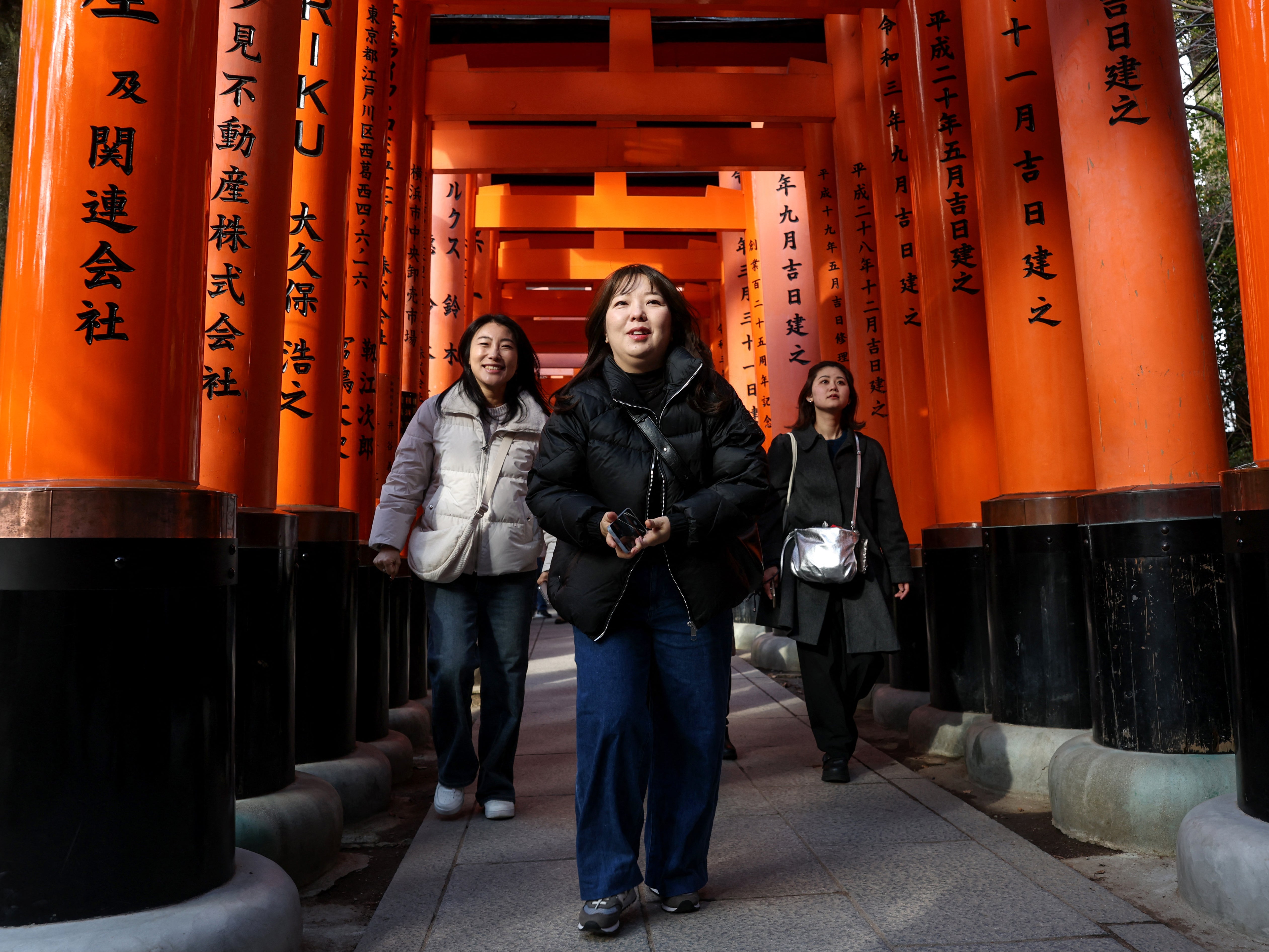 Tourists visit Fushimi Inari Shrine in the city of Kyoto on 13 January 2025