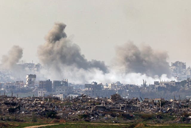 <p>This picture taken from the Israeli side of the border with the Gaza Strip shows smoke plumes rising from explosions above destroyed buildings in the northern Gaza Strip on January 14, 2025</p>