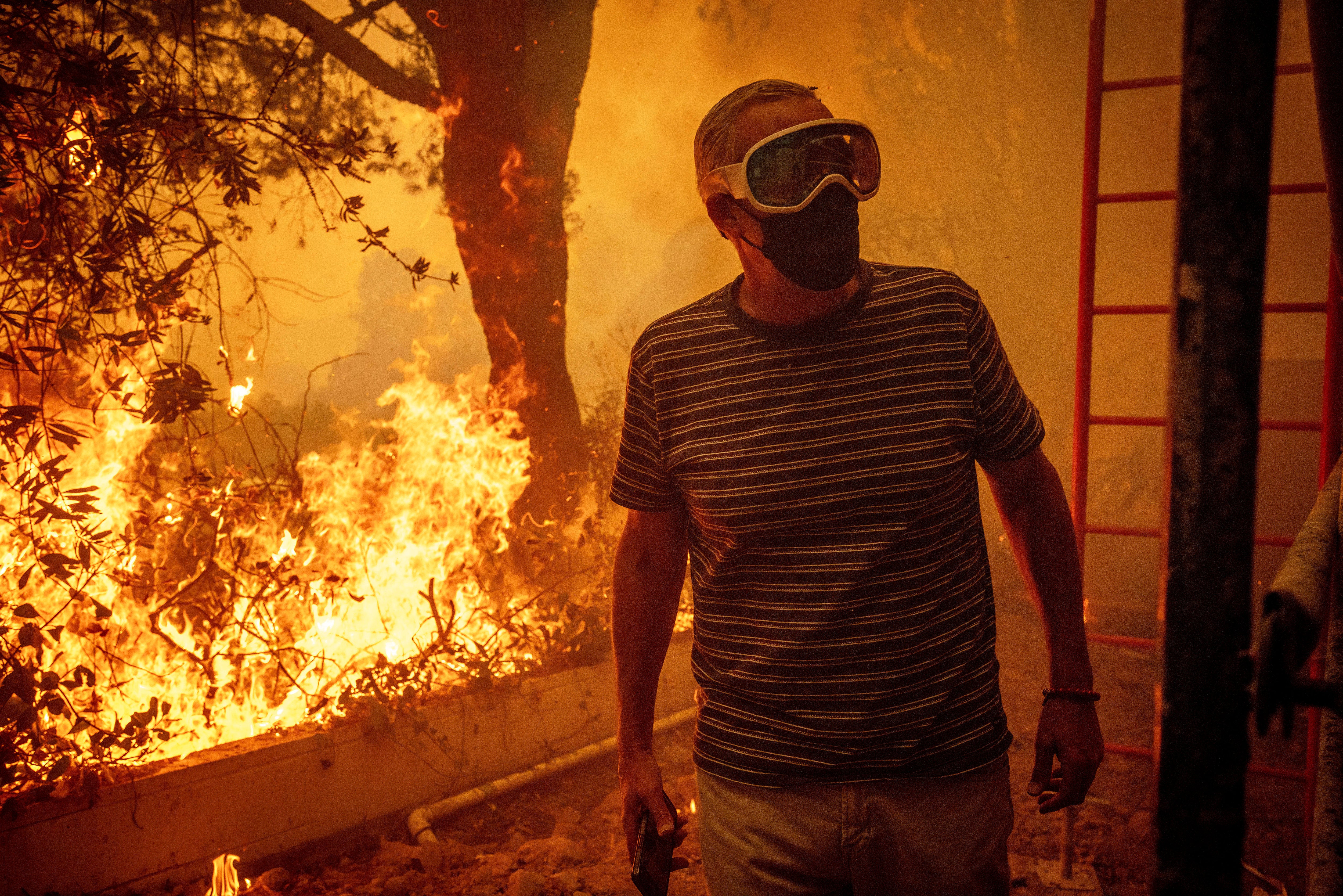 Will Adams watches as flames from the Palisades Fire close in on his property last week in the Pacific Palisades neighborhood of Los Angeles, California. The fires have sent toxic smoke into the air