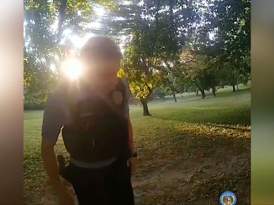 Former St Louis Police officer Austin Fraser examines a man who was dying from a gunshot wound to the head in Forest Park, Missouri, on September 10, 2023. Fraser told his partner, Ty Warren, he did not want to call in the incident because his shift was ending in 30 minutes. The officers then walked away from site without reporting the incident