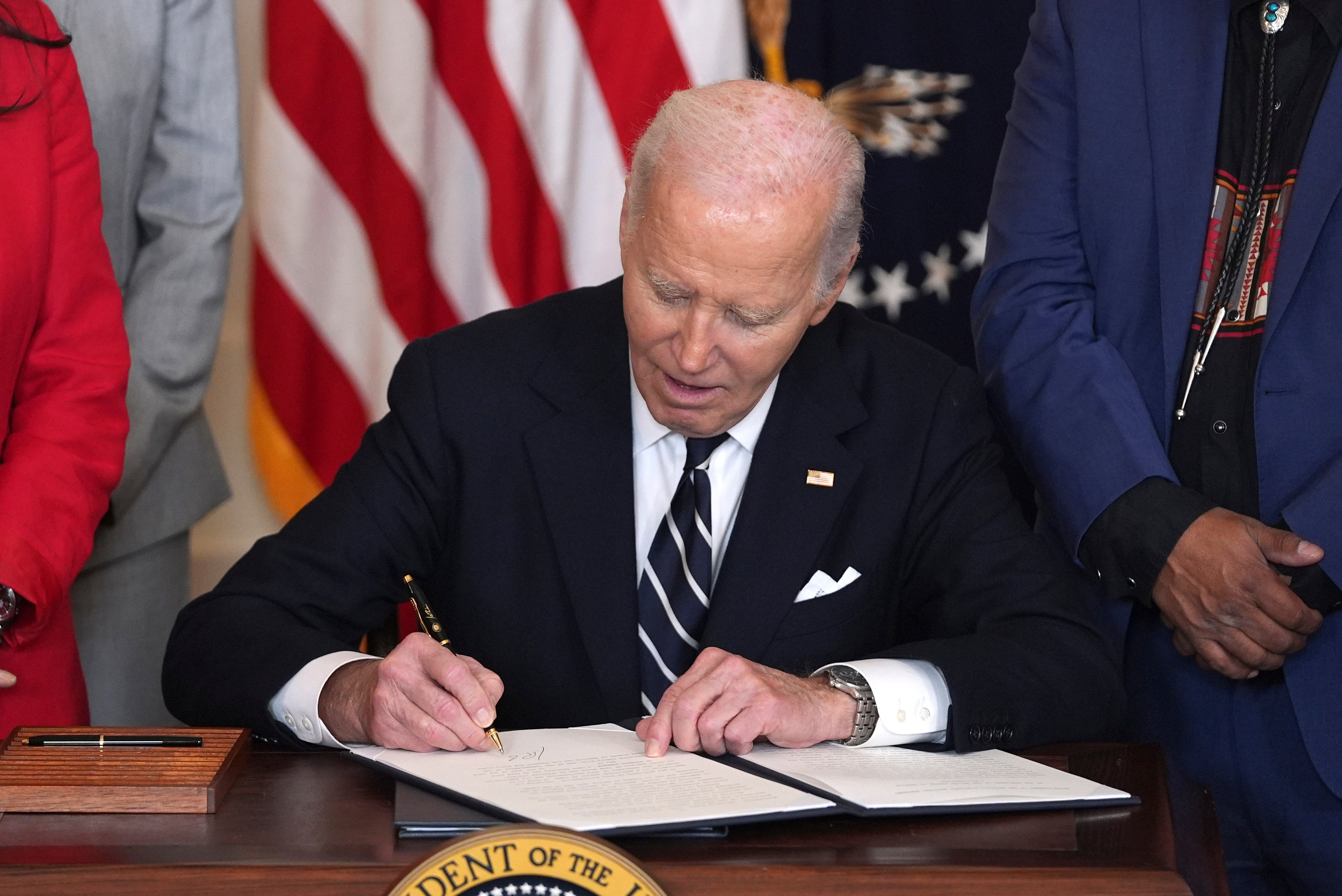 Biden, photographed signing a document in the East Room of the White House on January 14, reportedly rarely used autopen