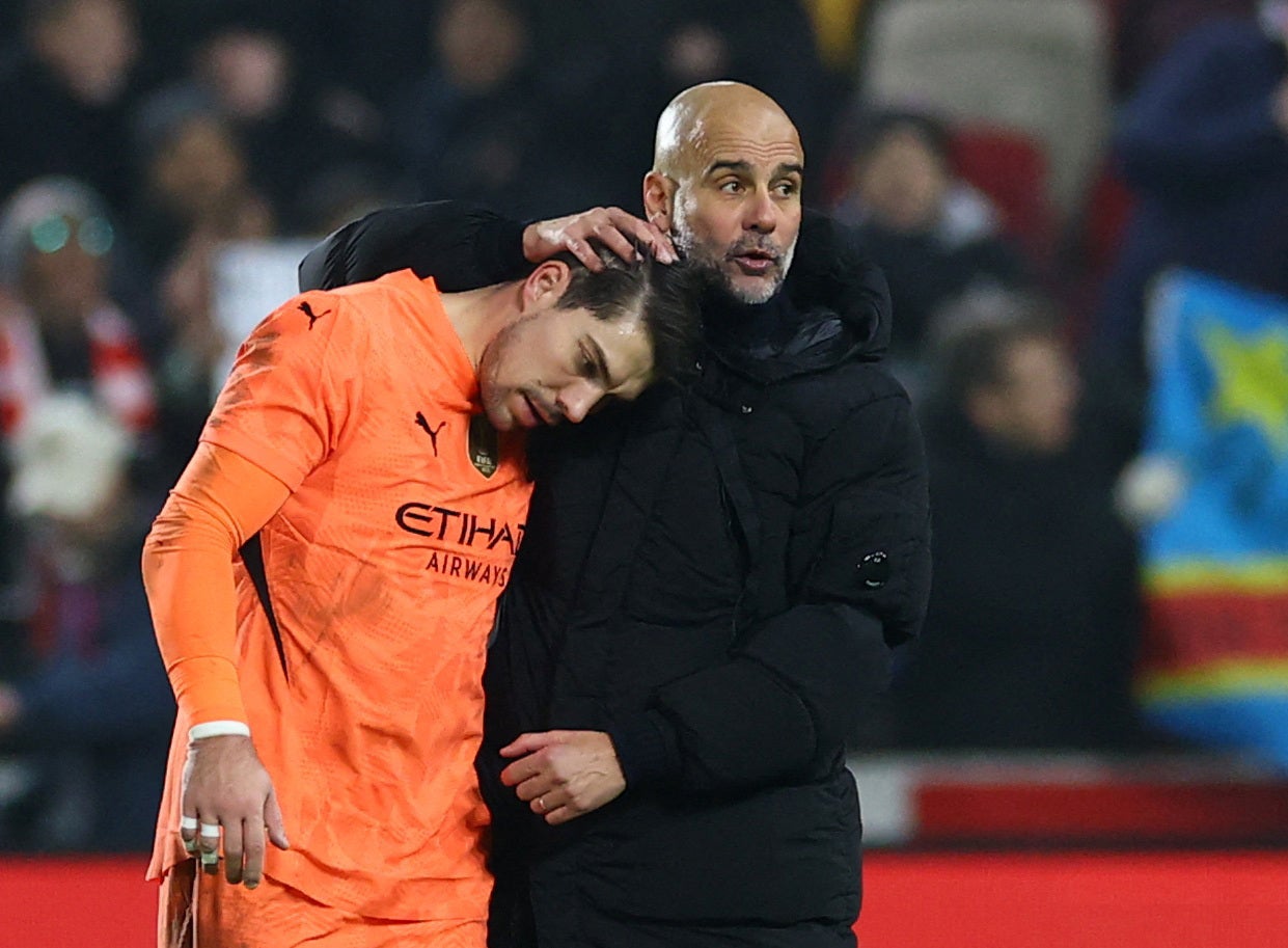 <p>Pep Guardiola consoles Stefan Ortega at the full-time whistle</p>