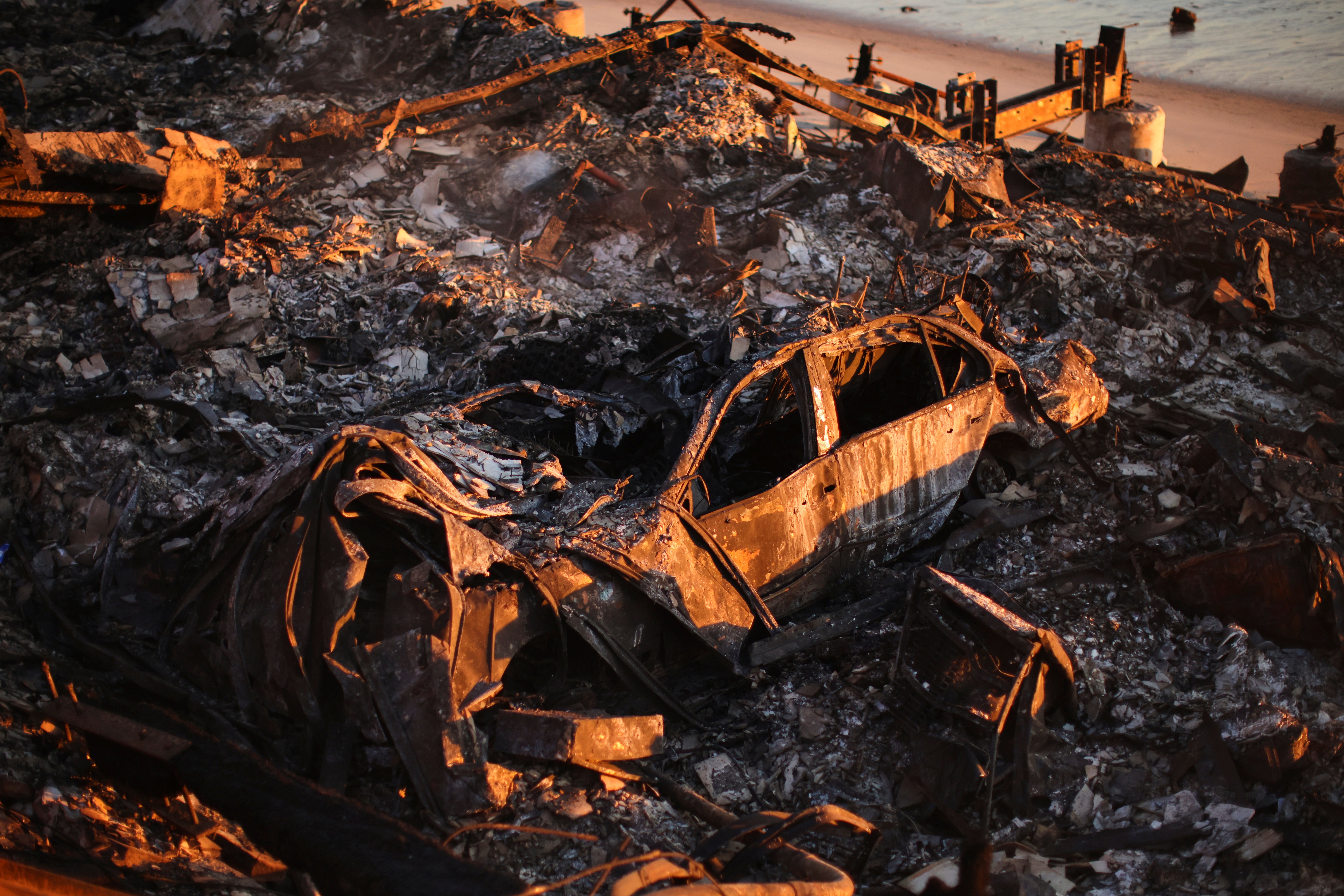 A burnt car is seen among the wreckage of a Malibu home destroyed by the Palisades Fire