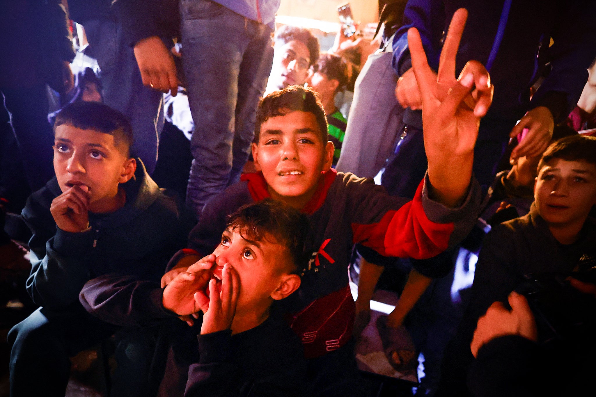 Palestinians react as they wait for news of a ceasefire deal with Israel, in Khan Younis in the southern Gaza Strip