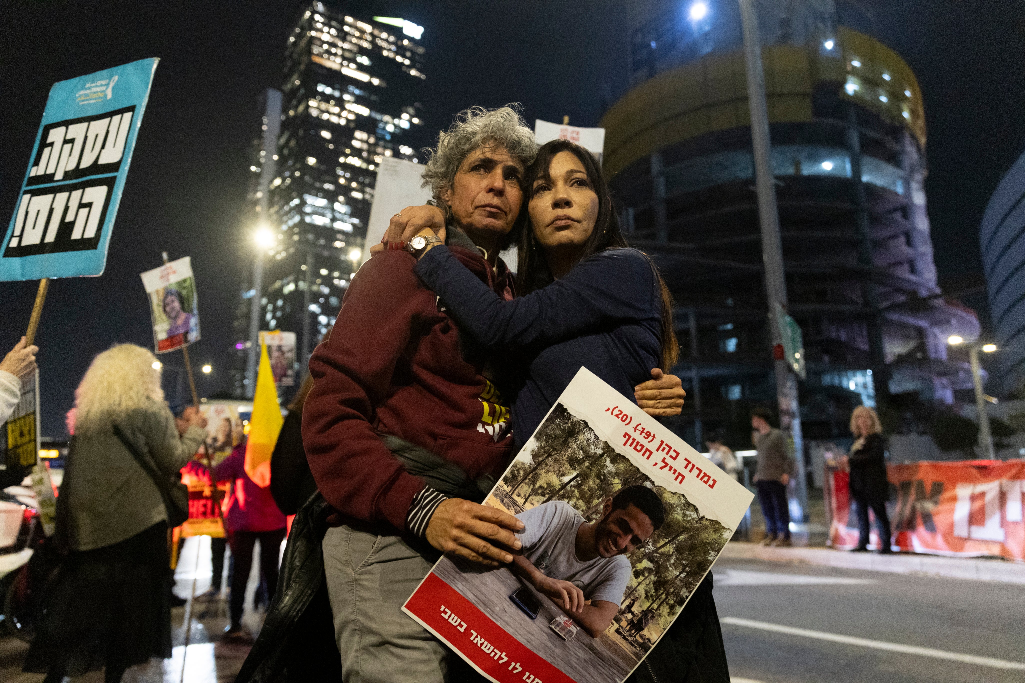 Protesters calling for the return of hostages held in the Gaza Strip react following the news