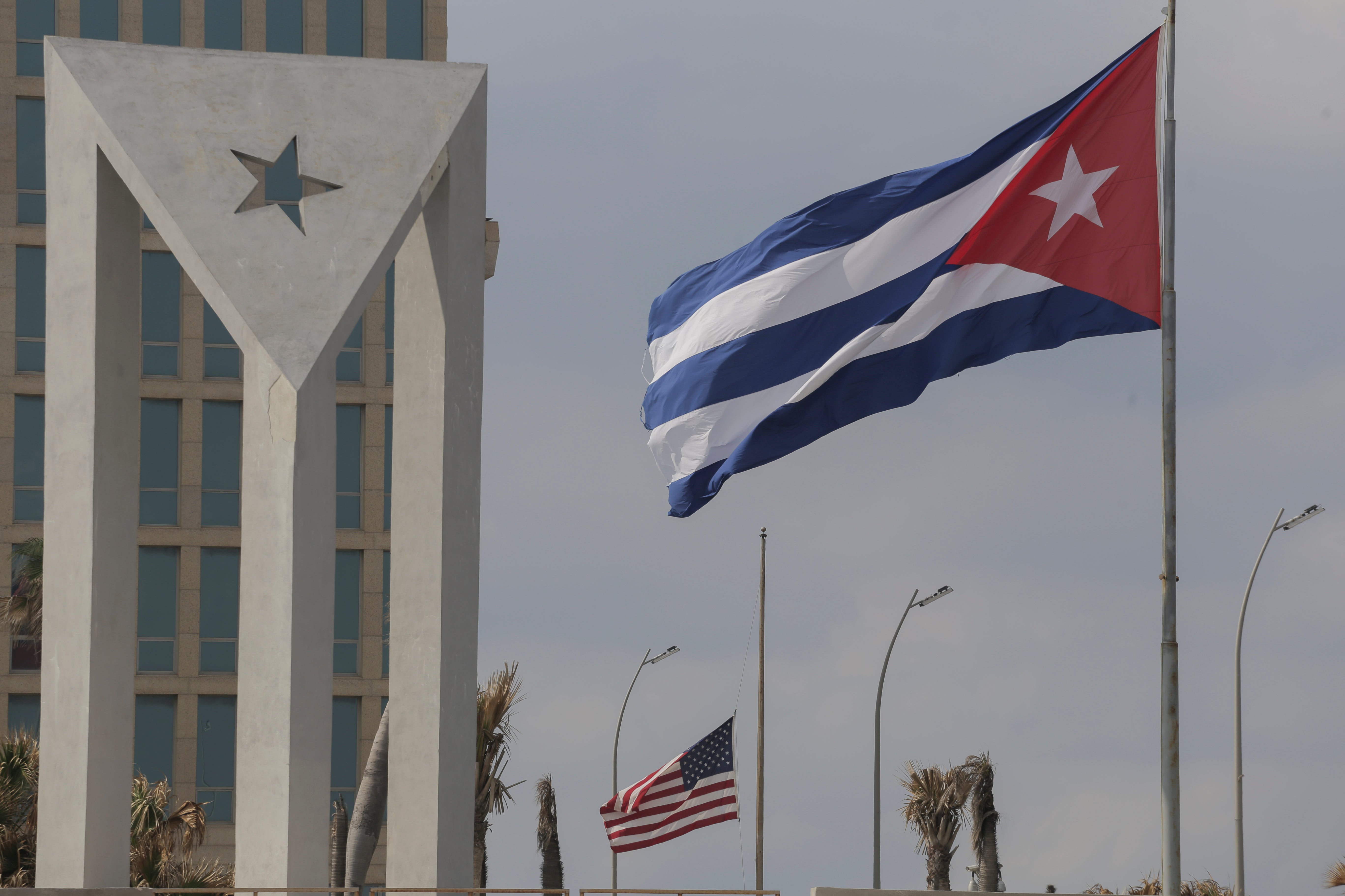 Cuban and American flags fly in the wind outside the American embassy in Havana, Cuba, Tuesday, Jan.14