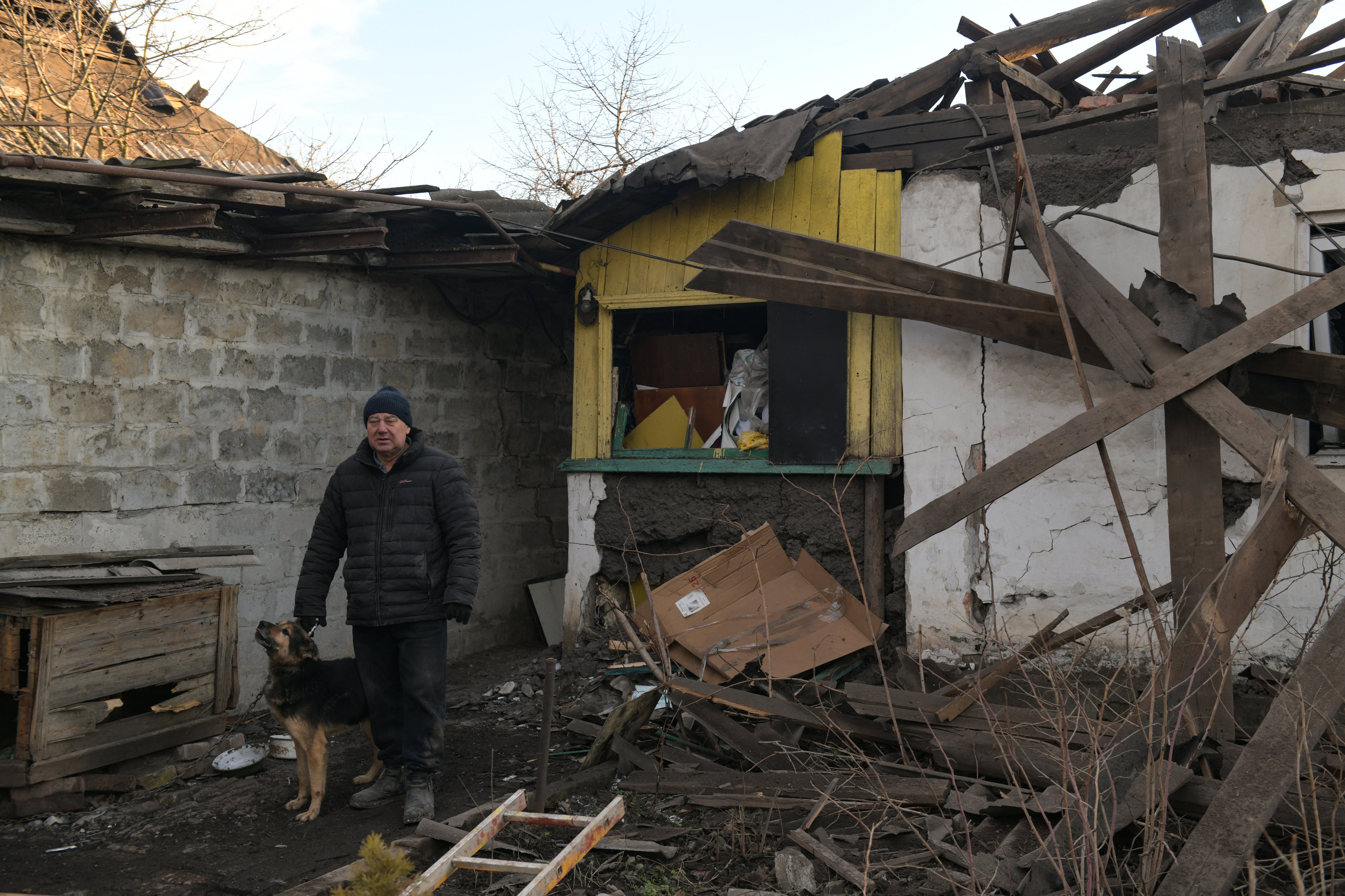 A local resident overlooks his destroyed house following shelling in Makiivka (Makeyevka) in the Donetsk region