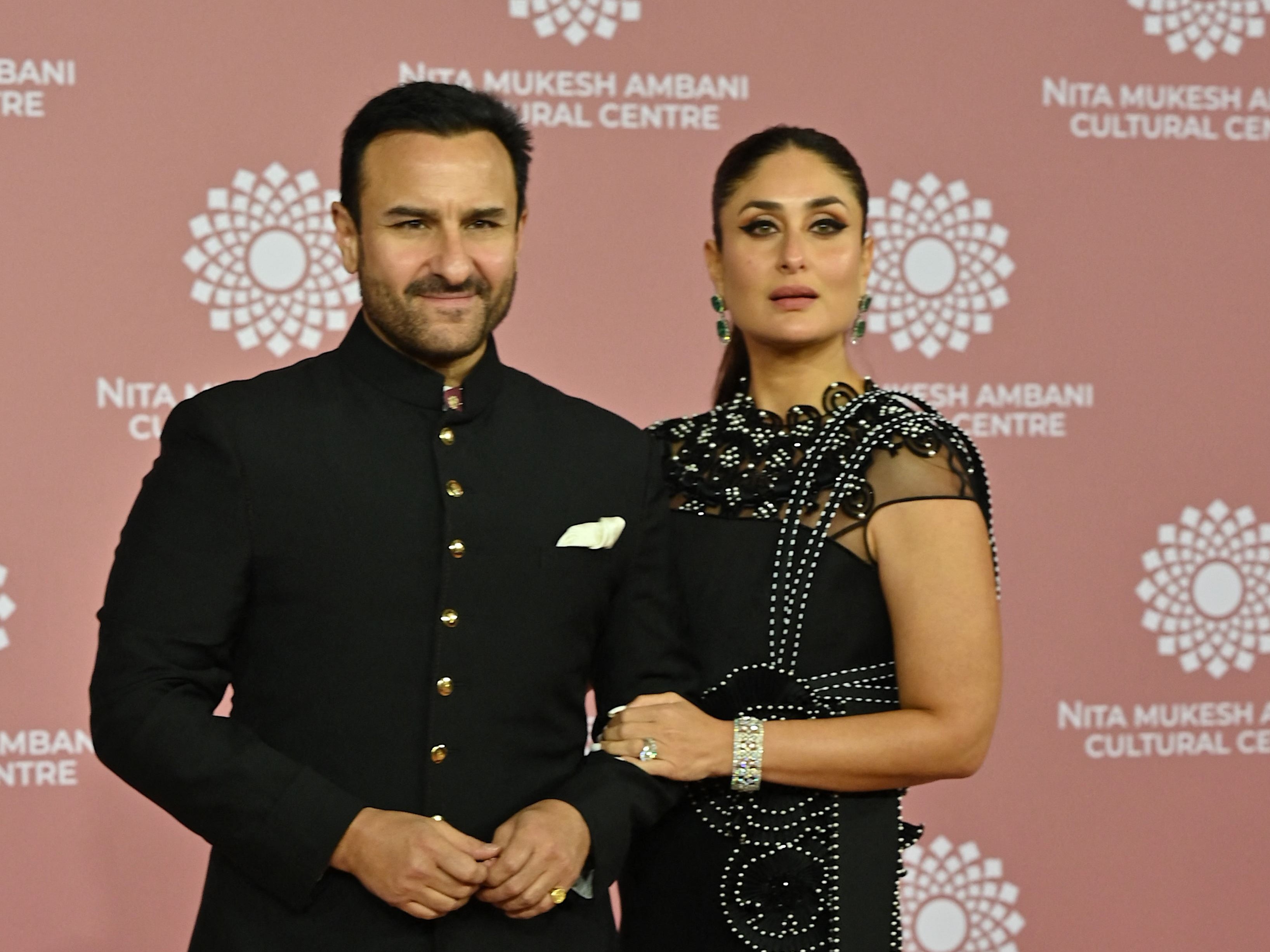 In this picture taken on 1 April 2023, Bollywood actors Saif Ali Khan (L) and Kareena Kapoor poses for pictures during the inauguration of the Nita Mukesh Ambani Cultural Centre (NMACC) at the Jio World Centre (JWC) in Mumbai