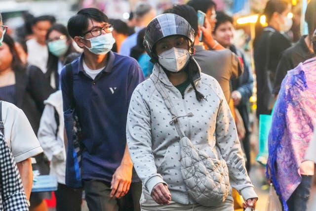 <p>A woman wears a sweater in Bangkok as Thailand experiences a run of cooler weather</p>