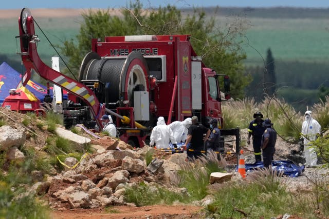 <p>Forensic workers at the site of the abandoned gold mine in Stilfontein, South Africa, on Wednesday</p>