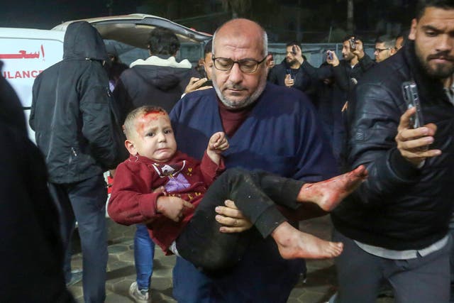 <p>A child wounded in an Israeli strike is rushed to the Al-Aqsa Martyrs Hospital in Deir al-Balah, Gaza on Thursday </p>