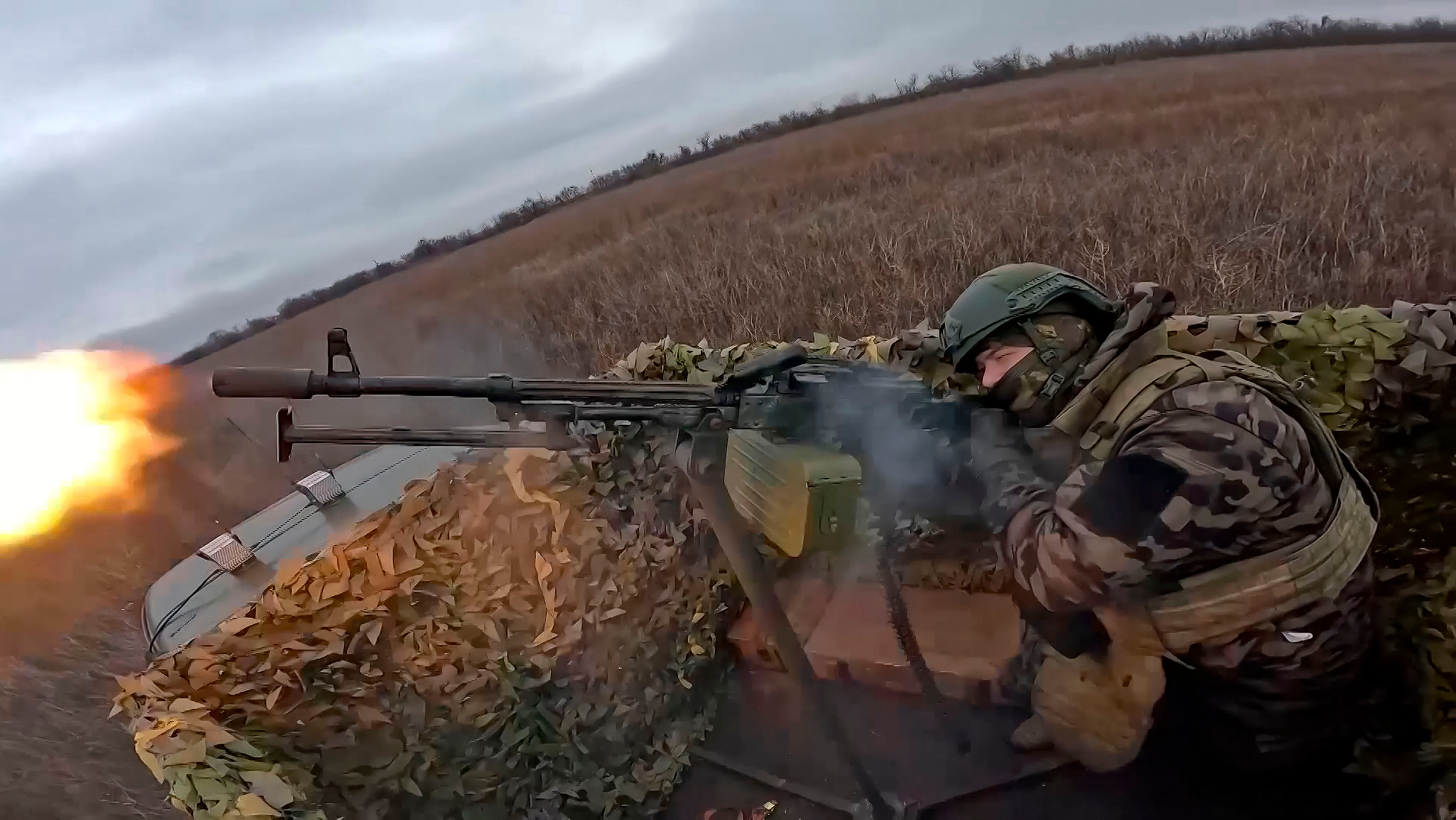 In this photo, taken from video and released by the Russian Defense Ministry Press Service on Thursday, Jan. 16, 2025, a Russian soldier tries to shoot a Ukrainian drone on an undisclosed location in Ukraine