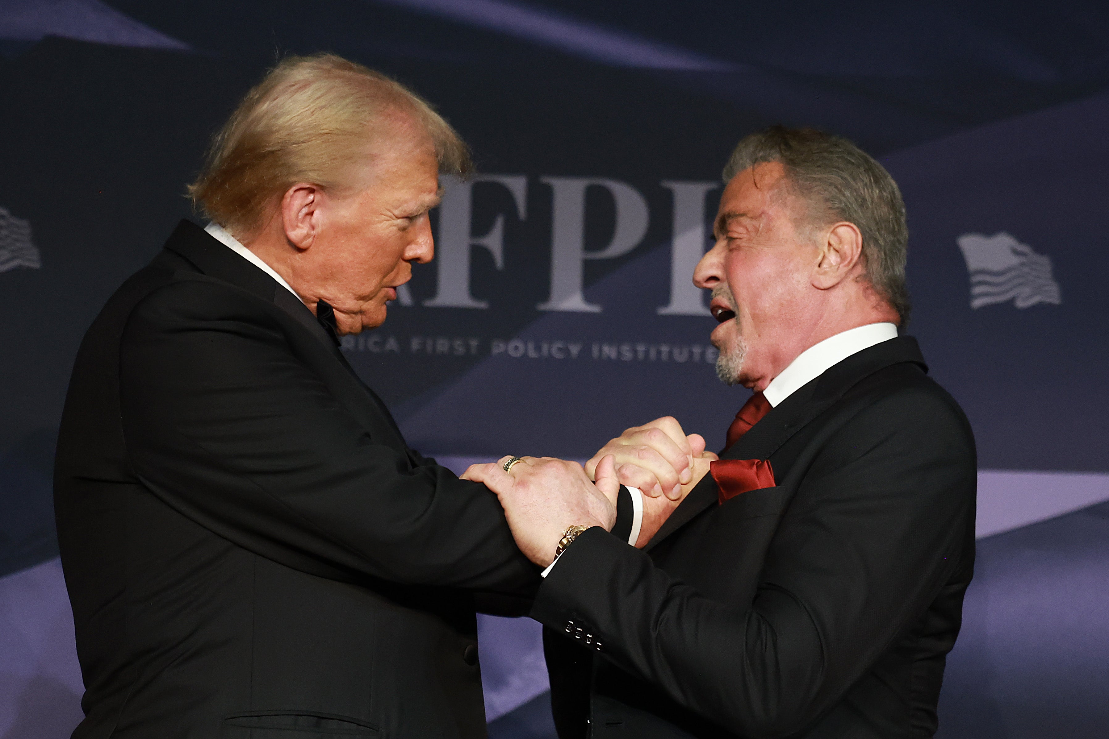 President-elect Donald Trump greets actor Sylvester Stallone onstage at the America First Policy Institute Gala. He is one of three movie stars appointed to serve as Trump’s envoys to Hollywood