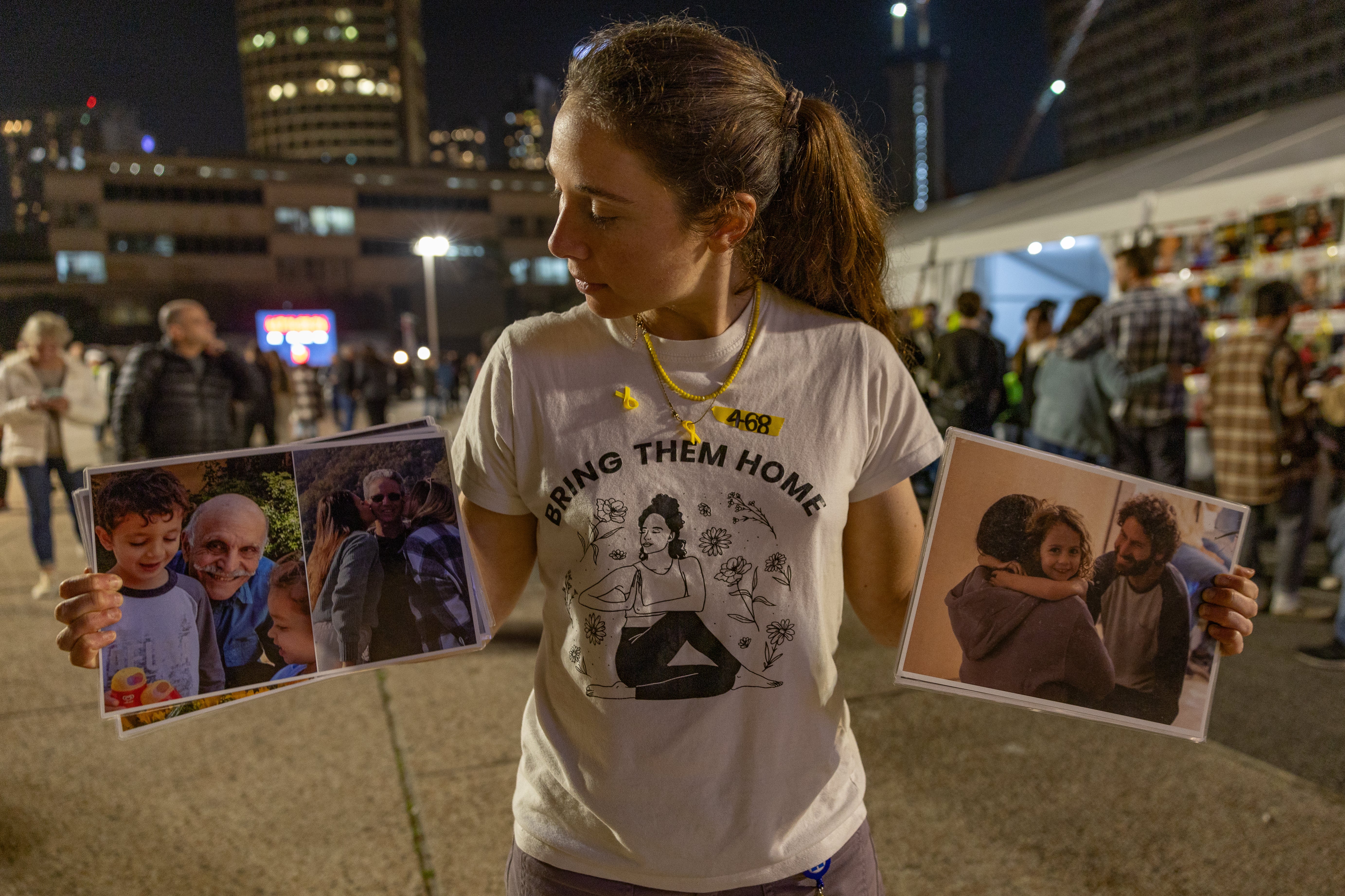 Shay Dickmann holds the image of her captured cousin (right) who will never make it home and the elderly male hostages who remain in Gaza and could be freed in the new deal