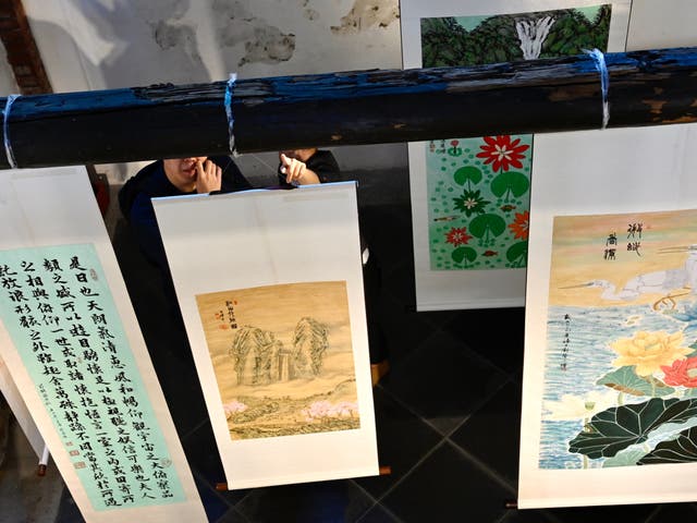 <p>File. People stand behind artwork during an exhibition entitled ‘Not Who We Were’ organised by the Taiwan Alliance to End the Death Penalty in Taipei on 18 July 2020</p>