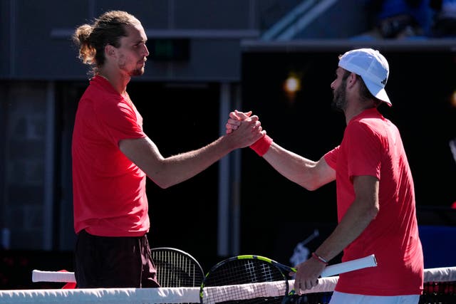 Jacob Fearnley, right, shakes hands with Alexander Zverev (Vincent Thian/AP)