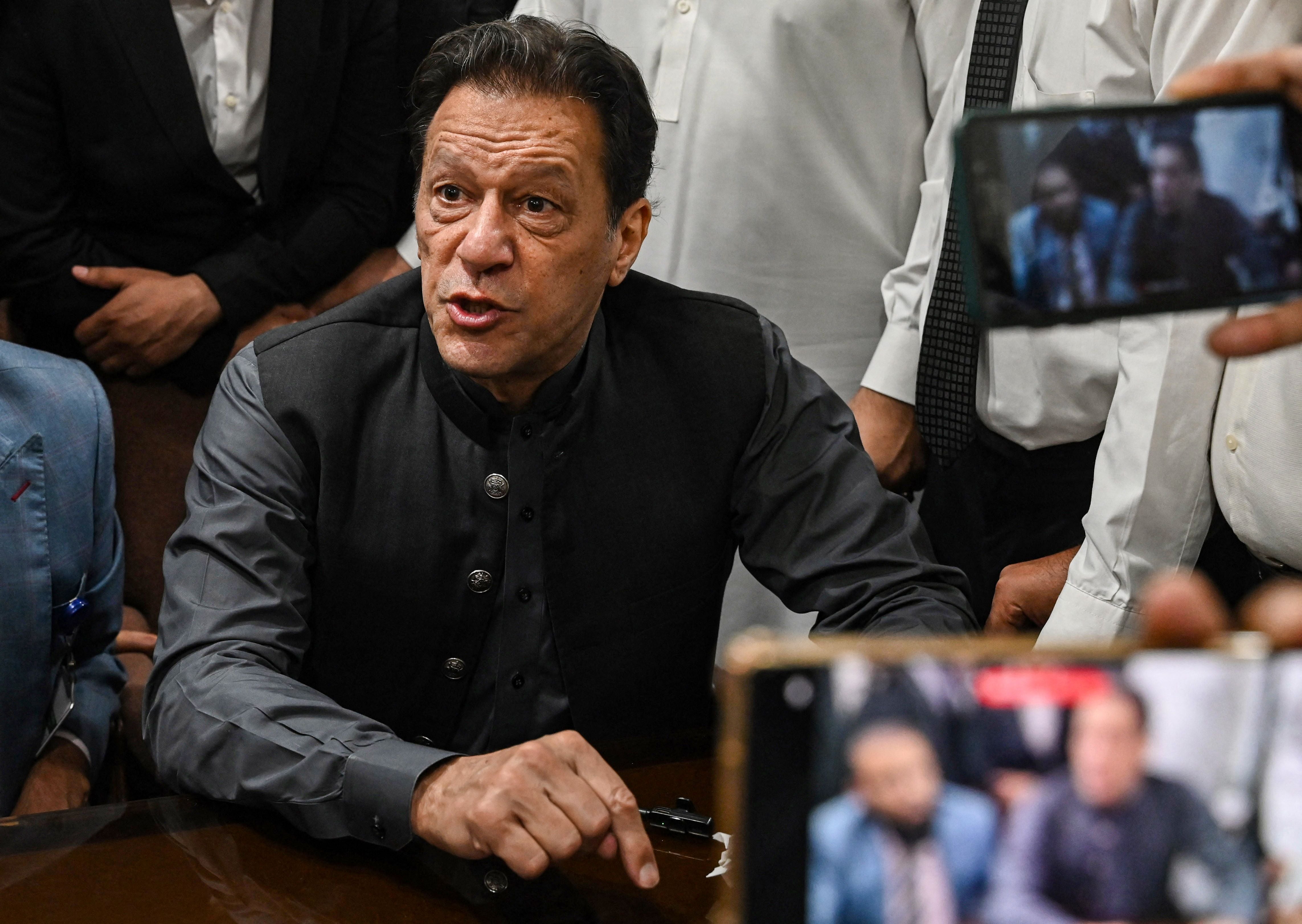 Imran Khan gestures after arriving at a registrar office in Lahore High court in July 2023