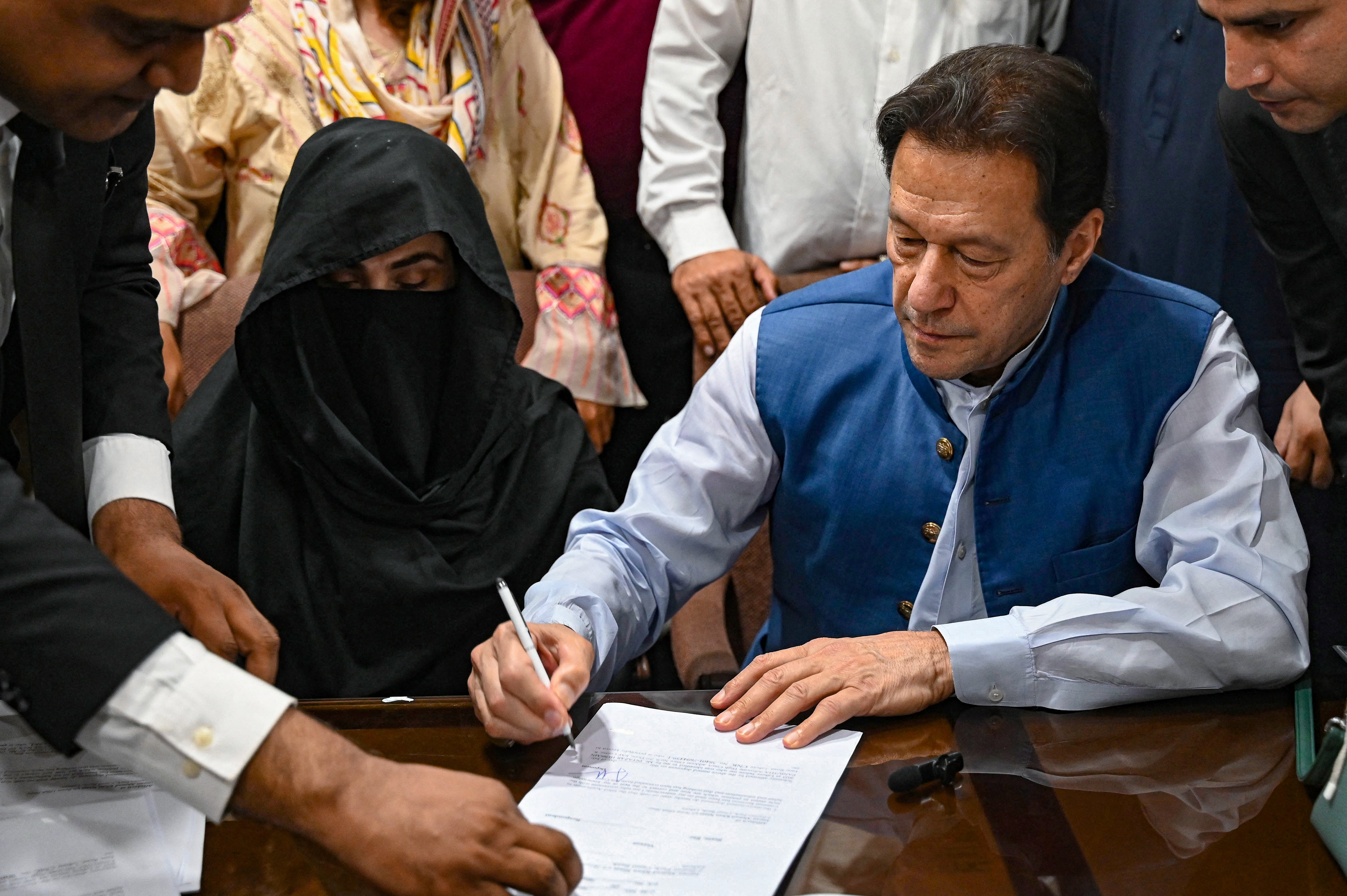 Imran Khan along with his wife Bushra Bibi signs surety bonds for bail in various cases in Lahore