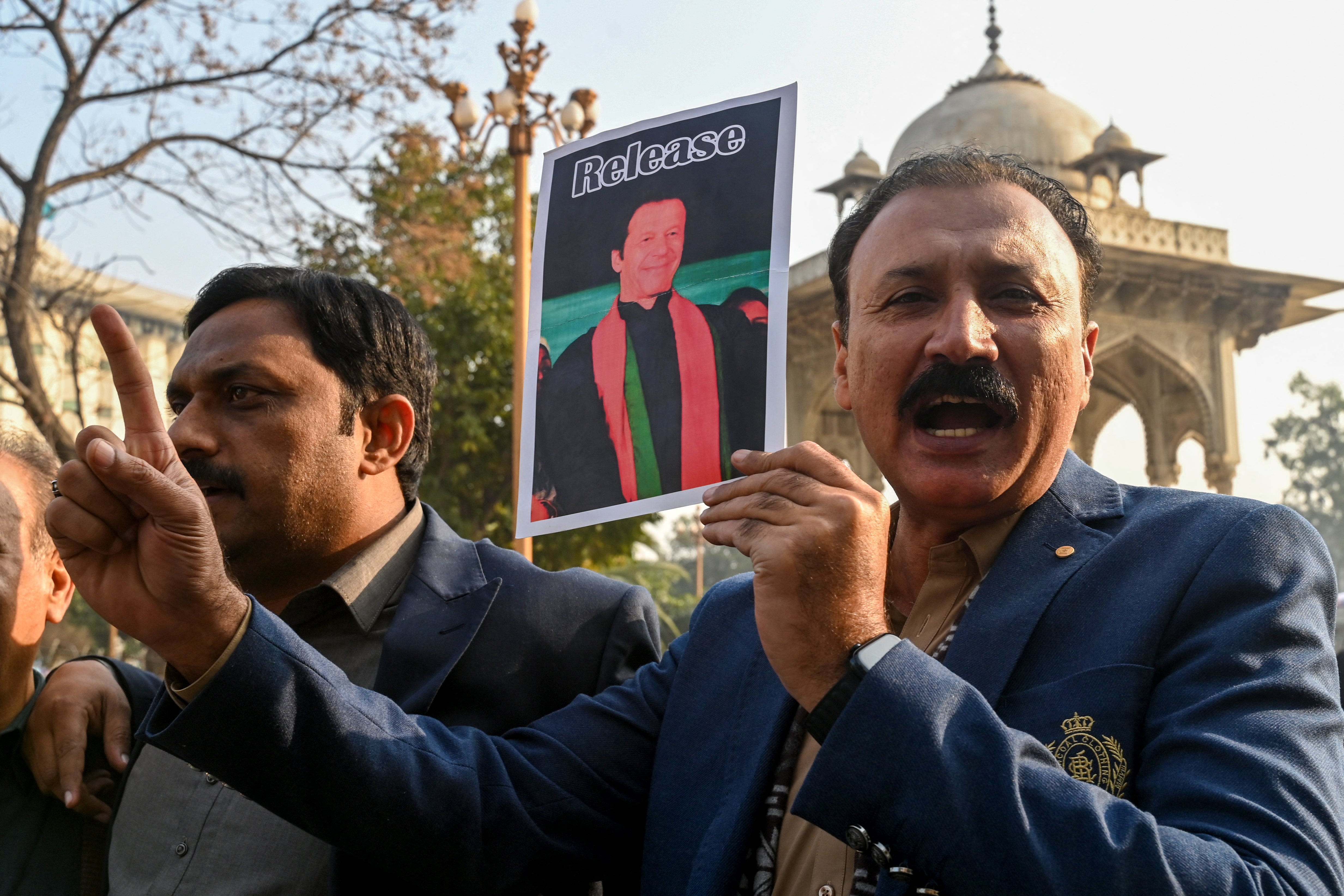 Supporters of jailed former prime minister Imran Khan hold up his portrait during a protest in Lahore, January 17, 2025.