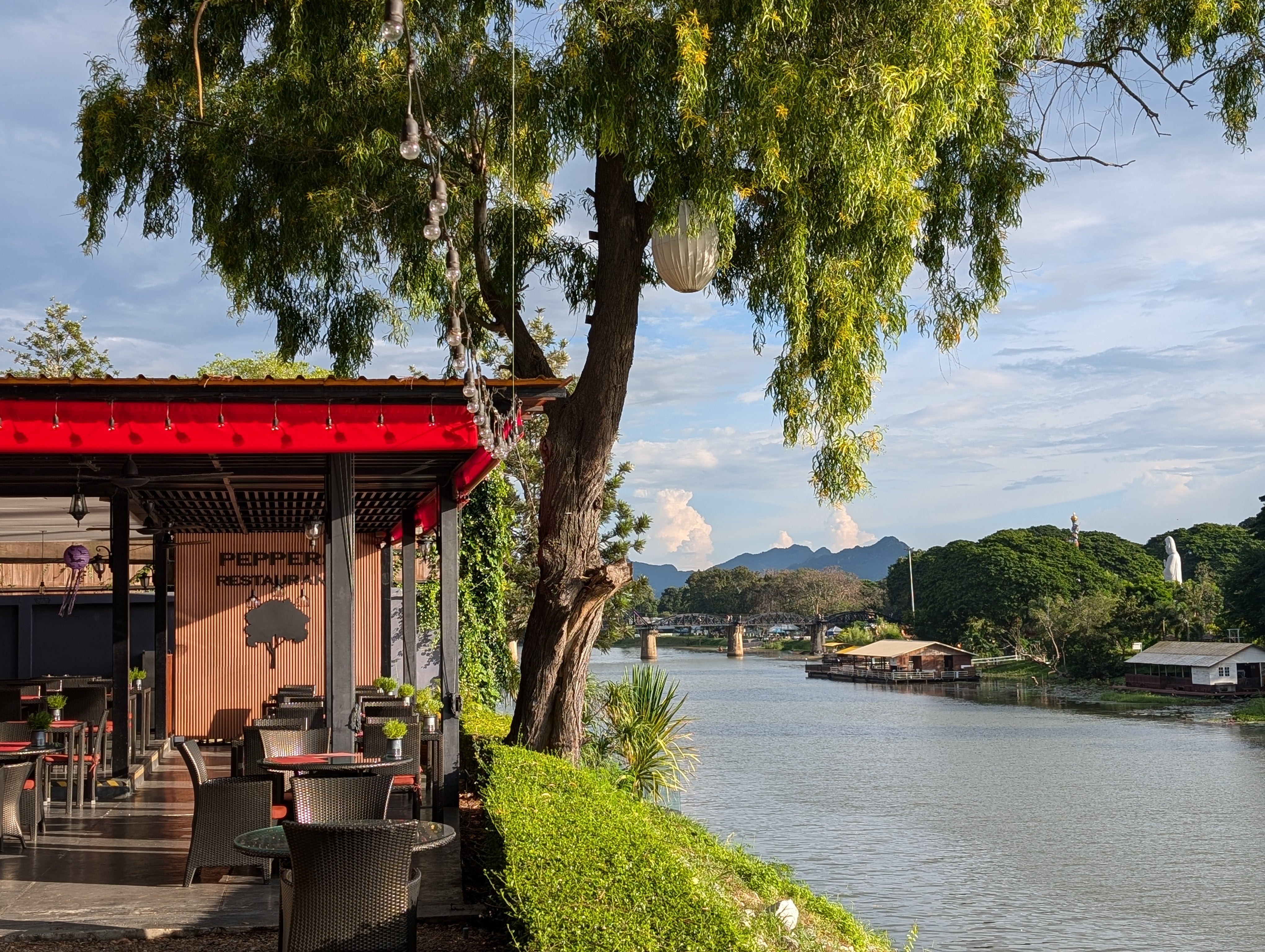 Dinner with a view extending over the Ping river, towards distant gossamer mountains