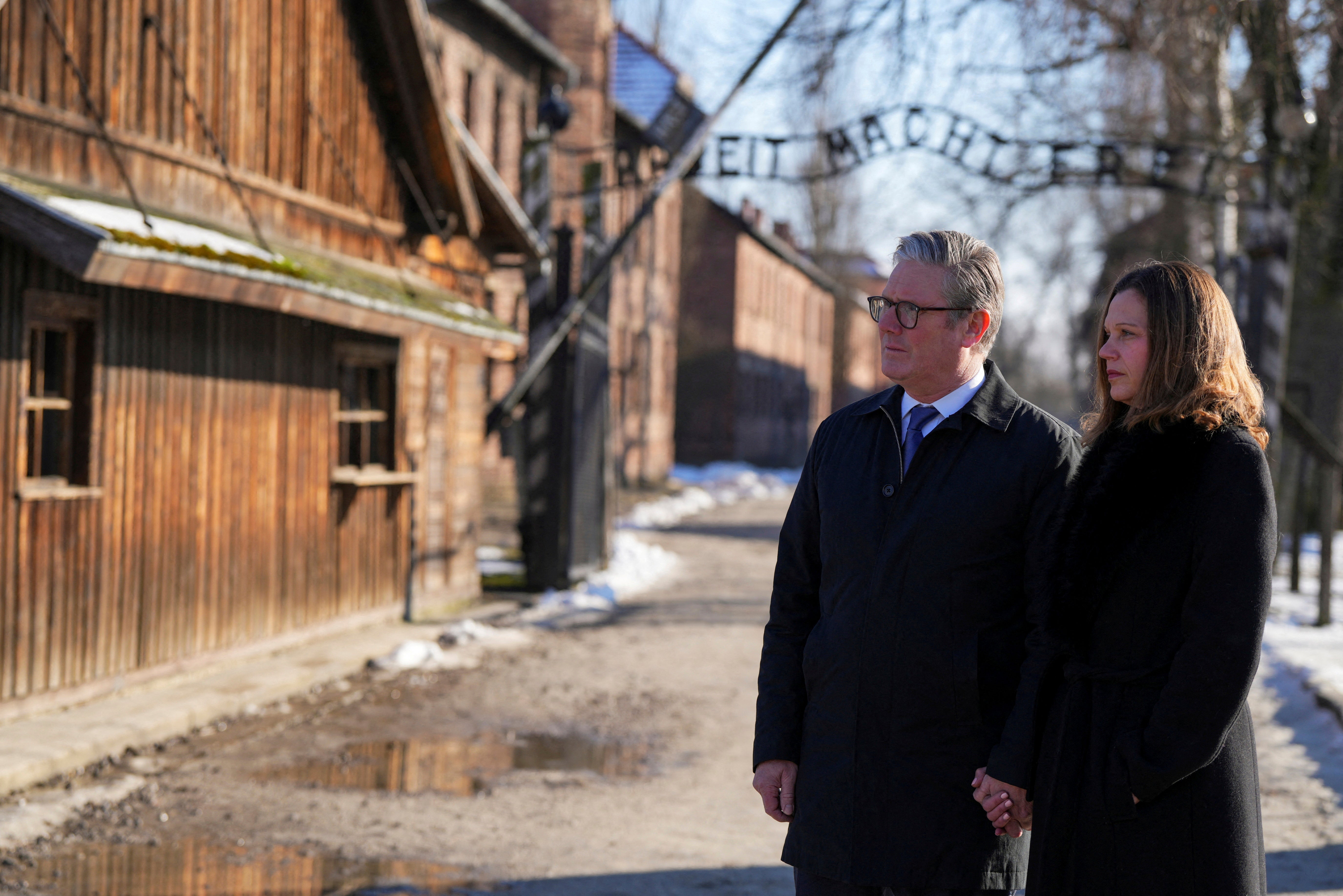 Sir Keir Starmer and Victoria Starmer walk through Auschwitz