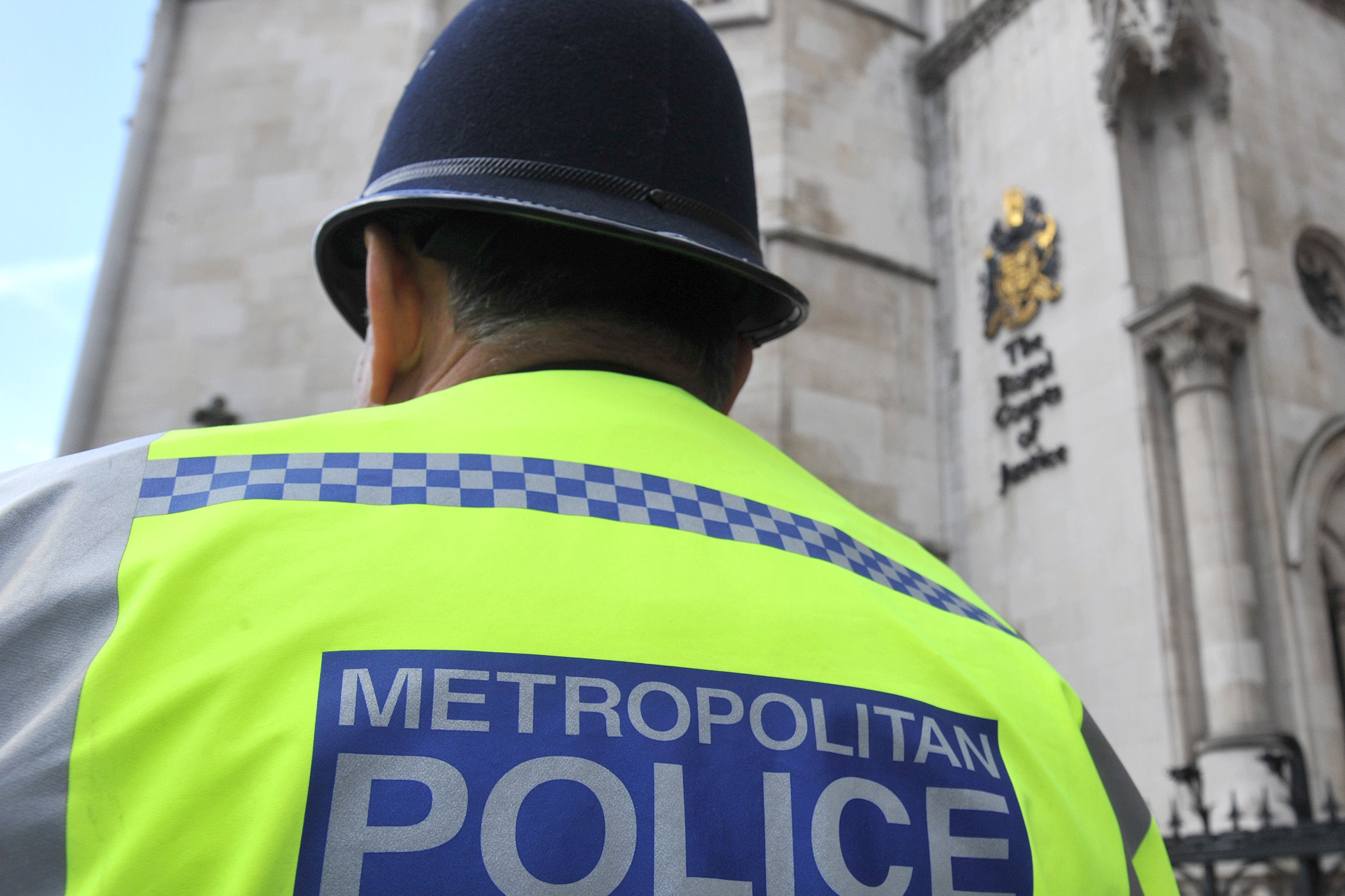 A Metropolitan Police officer outside the Royal Courts of Justice in central London (Nick Ansell/PA)