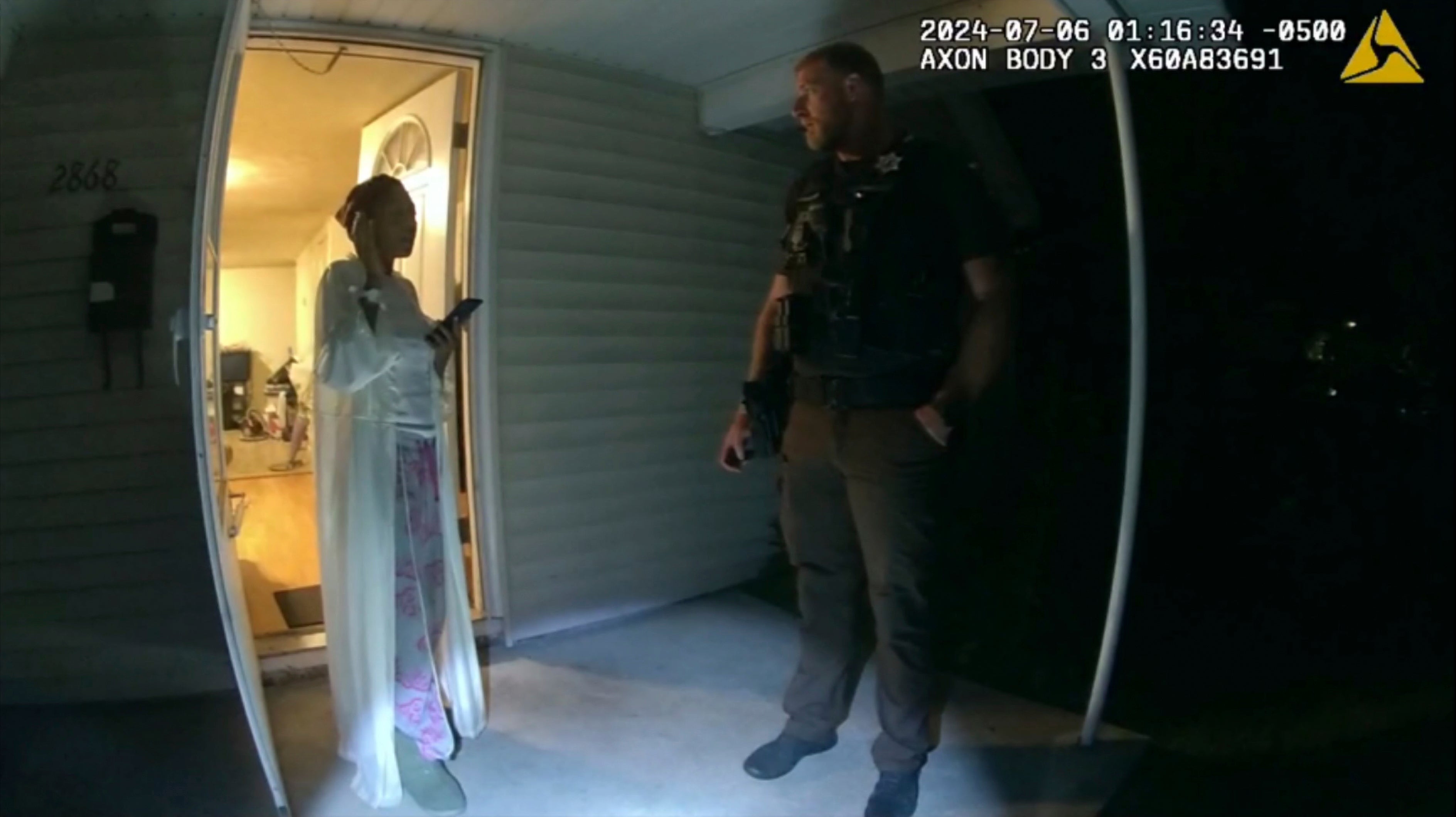 In this image taken from body camera video released by Illinois State Police, Massey, left, talks with former Sangamon County Sheriff's Deputy Sean Grayson outside her home in Springfield, Ill., July 6, 2024.