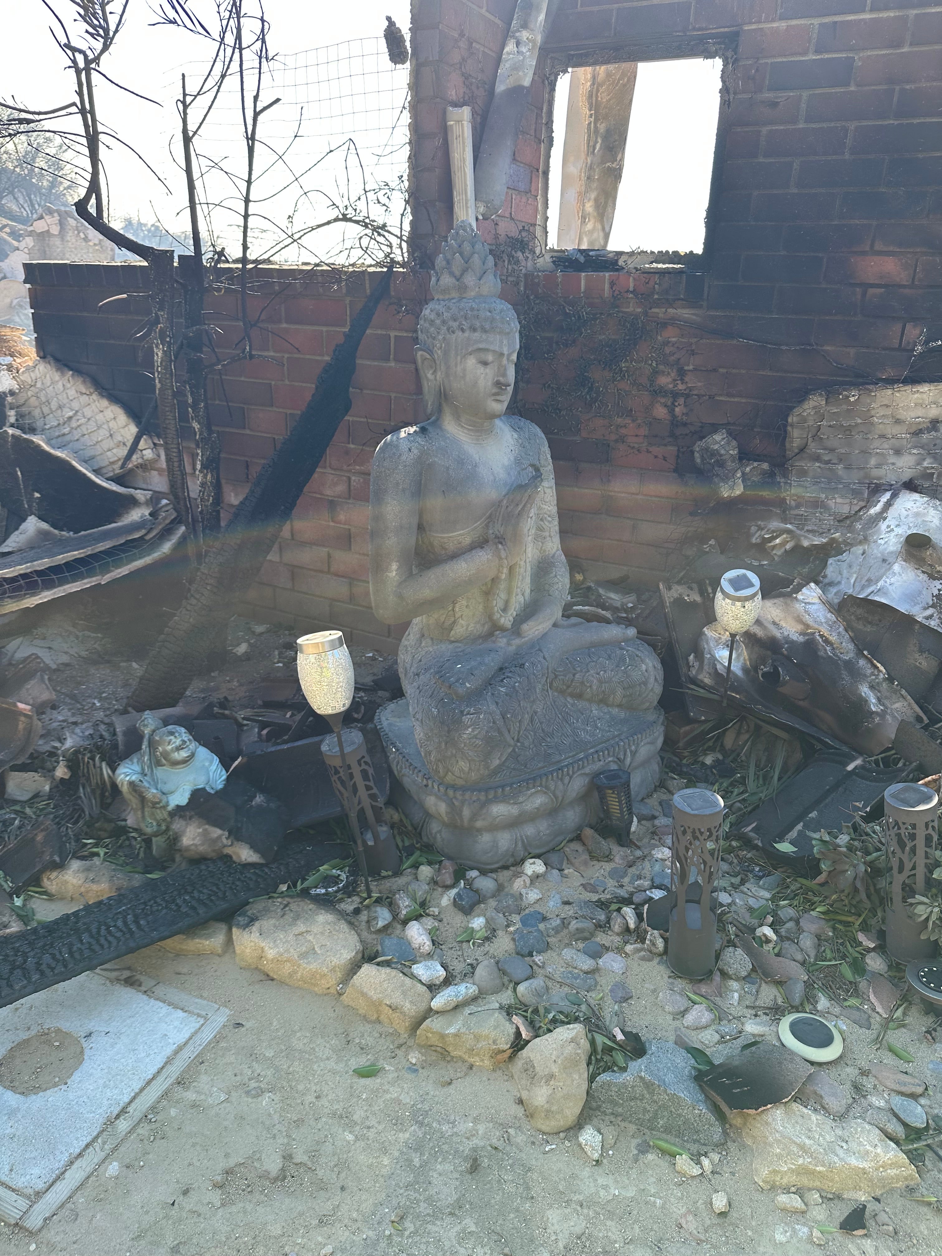 Two Buddha statues remained untouched by the fires, but the house was a total loss