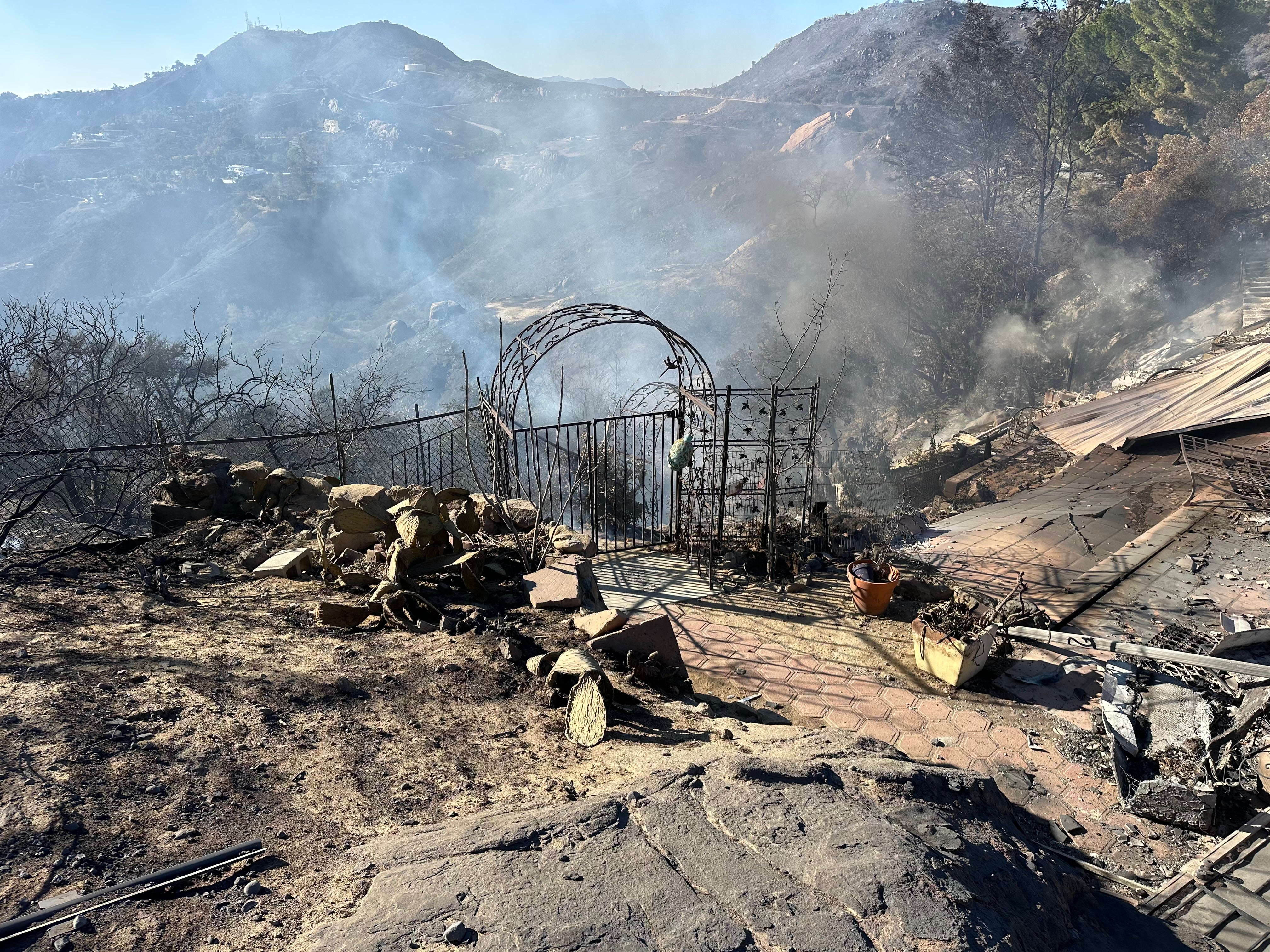 A door frame of the house sticks out of the burned down Topanga house