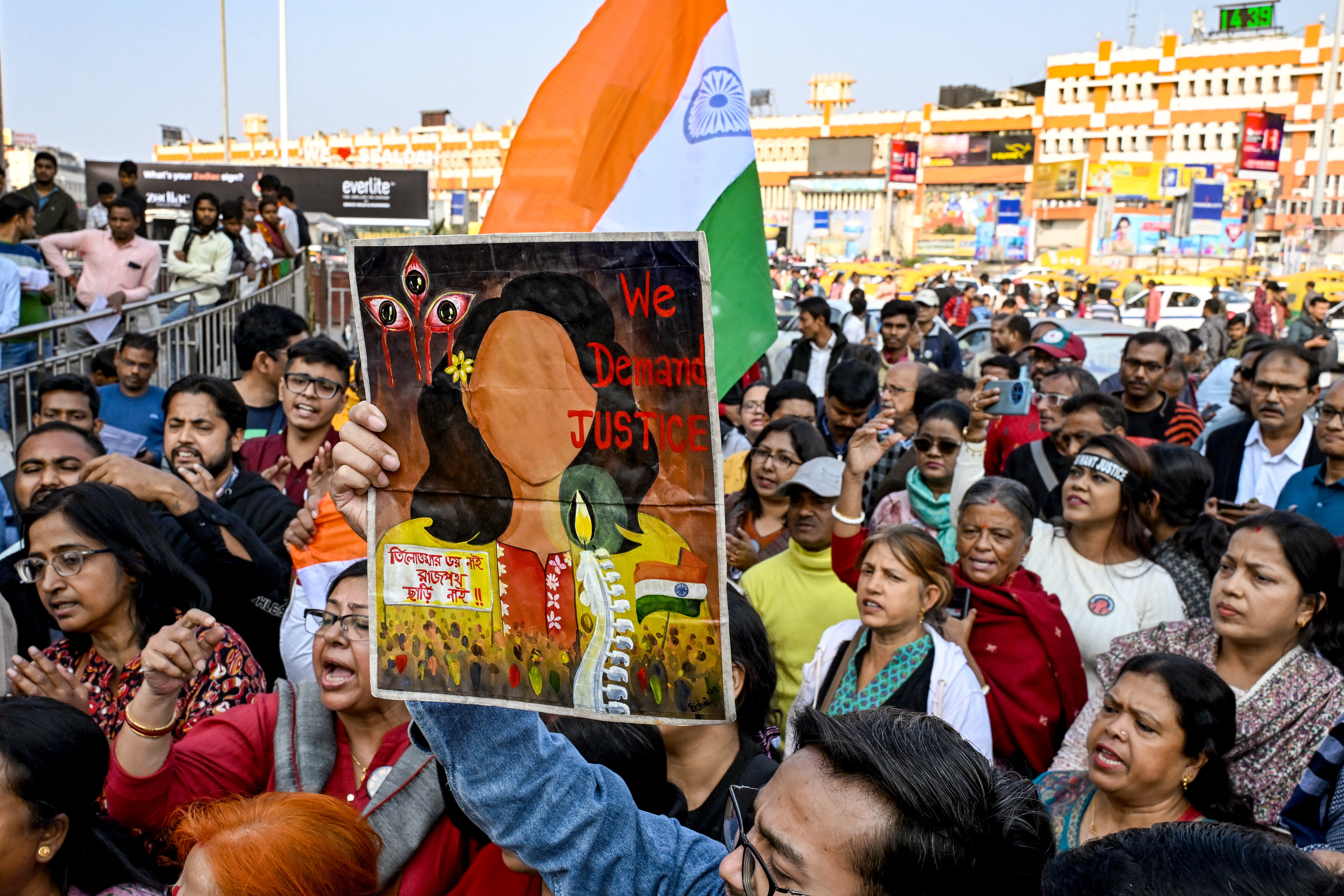 Activists shout slogans near the Kolkata court conducting the trial of Sajay Roy