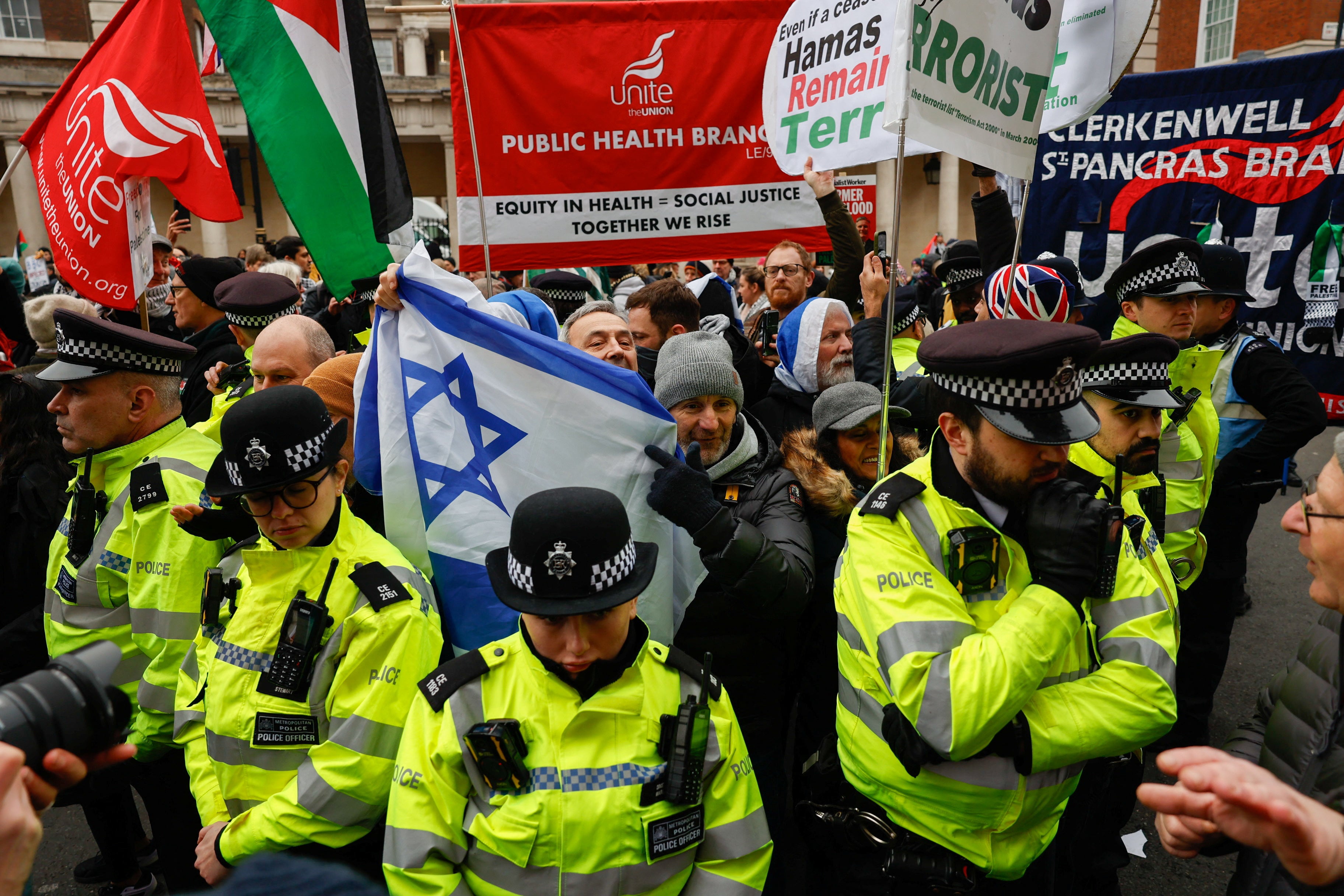 Pro-Israel counter protesters hold a flag of Israel