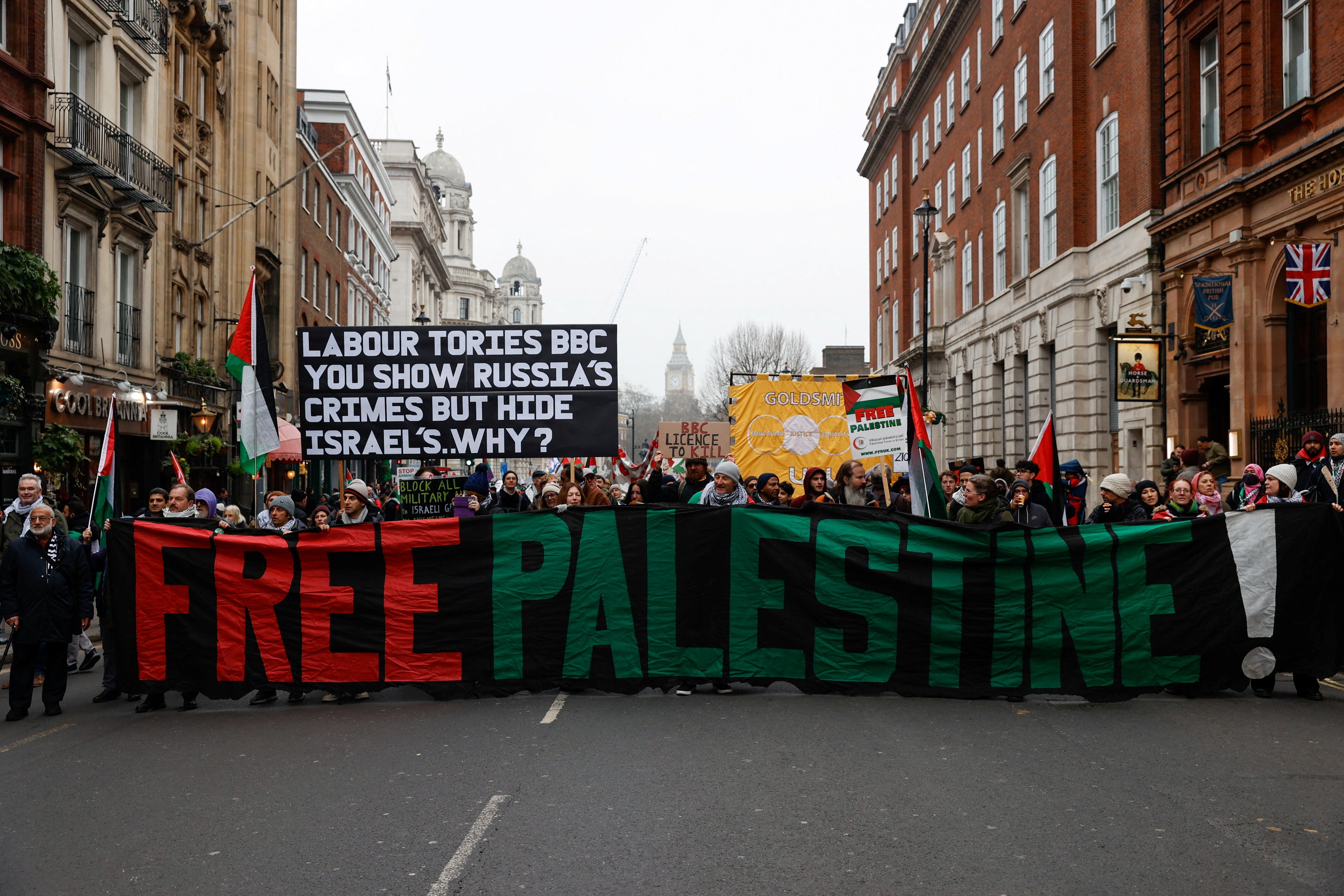 Protesters hold banners during a demonstration in support of Palestinians in Gaza, in London