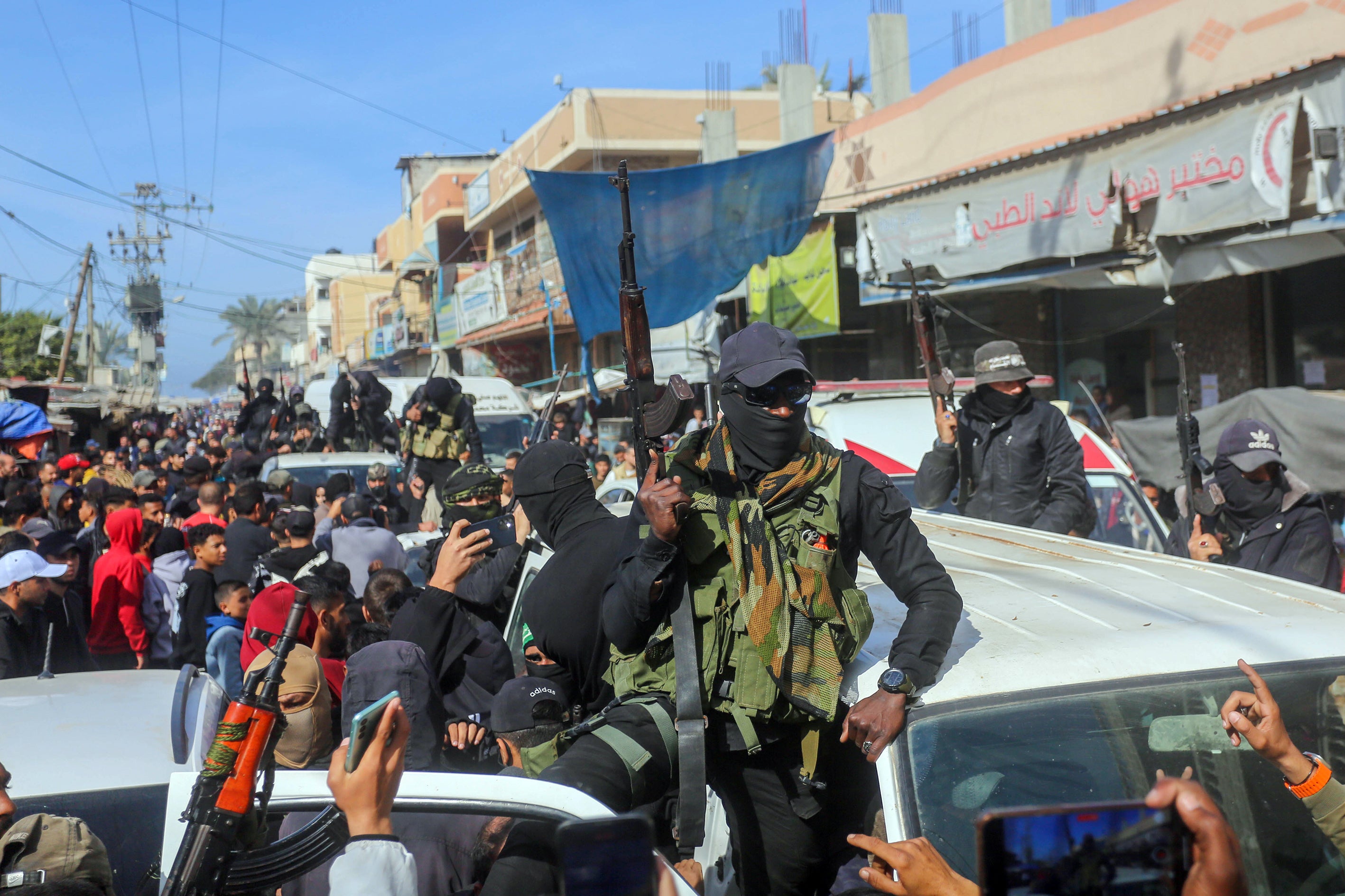 Civilians, some people carrying guns in their hands, demonstrate their joy after the announcement of ceasefire and hostage-prisoner swap