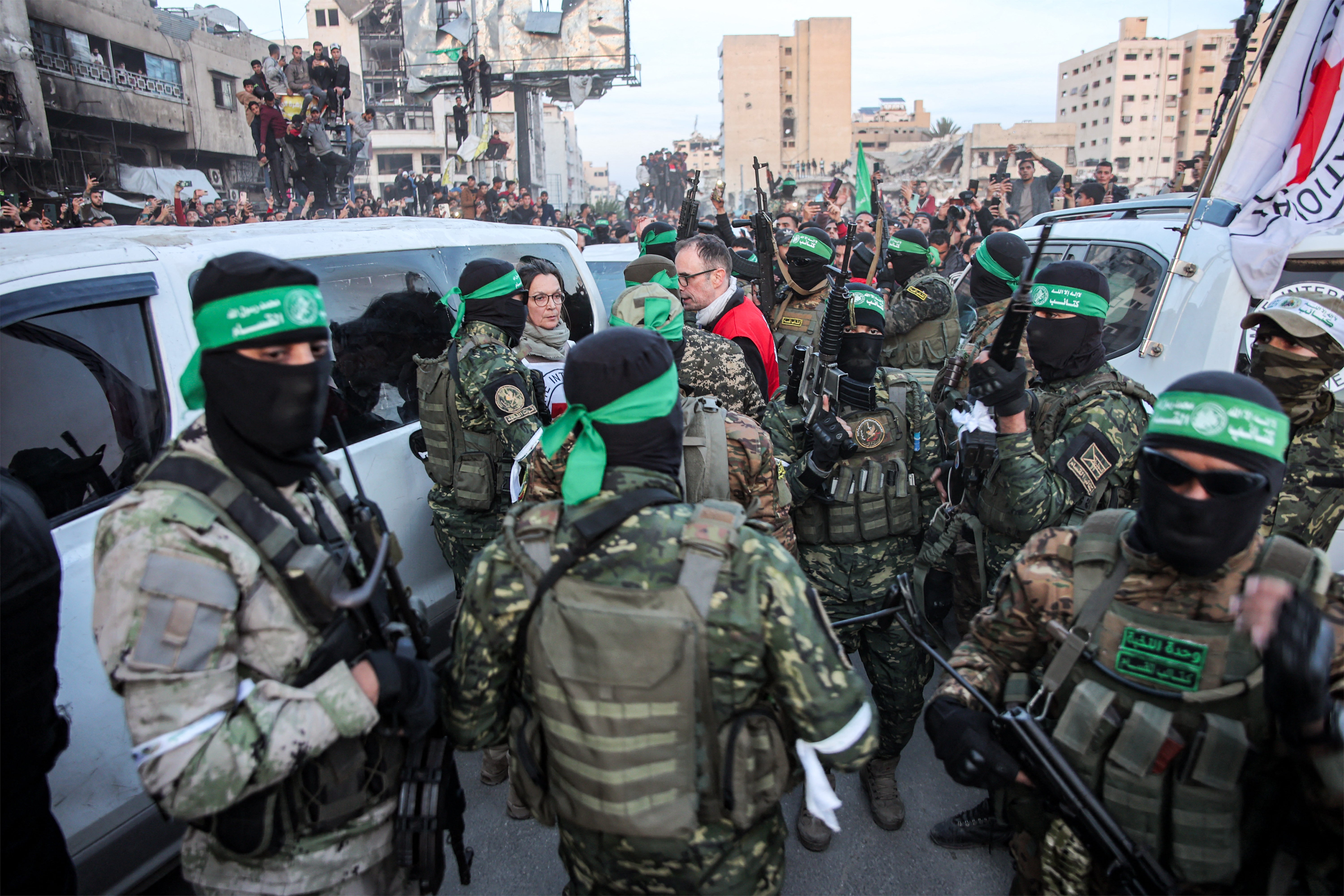 Members of the International Committee of the Red Cross (ICRC) speak with fighters of the Ezzedine al-Qassam Brigades, Hamas's armed wing, in Saraya Square in western Gaza