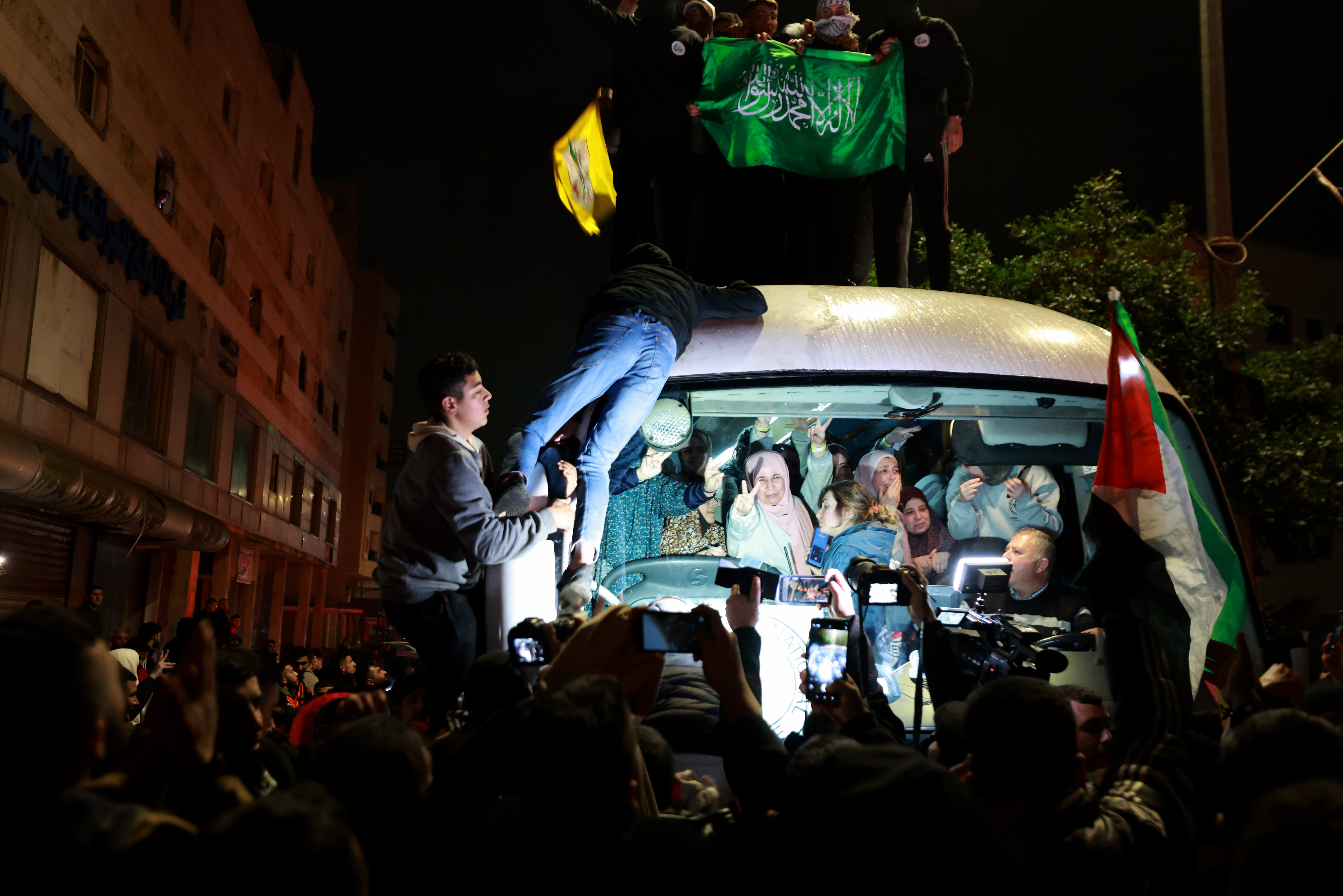 People react as a bus carrying released Palestinian prisoners from the Ofer Israeli military prison arrives in Ramallah