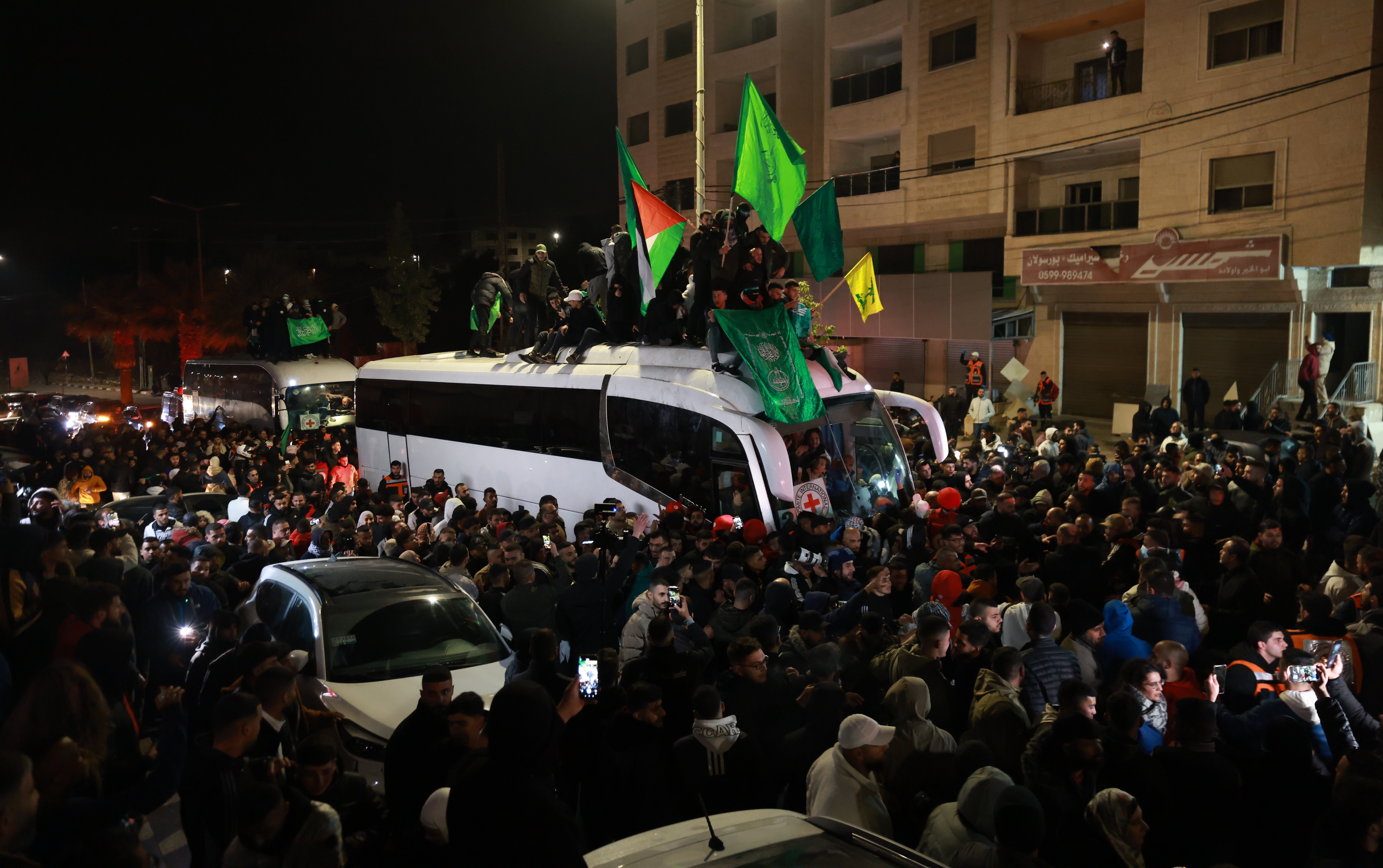 People react as a bus carrying released Palestinian prisoners from the Ofer Israeli military prison arrives in Ramallah, early 20 January 2025